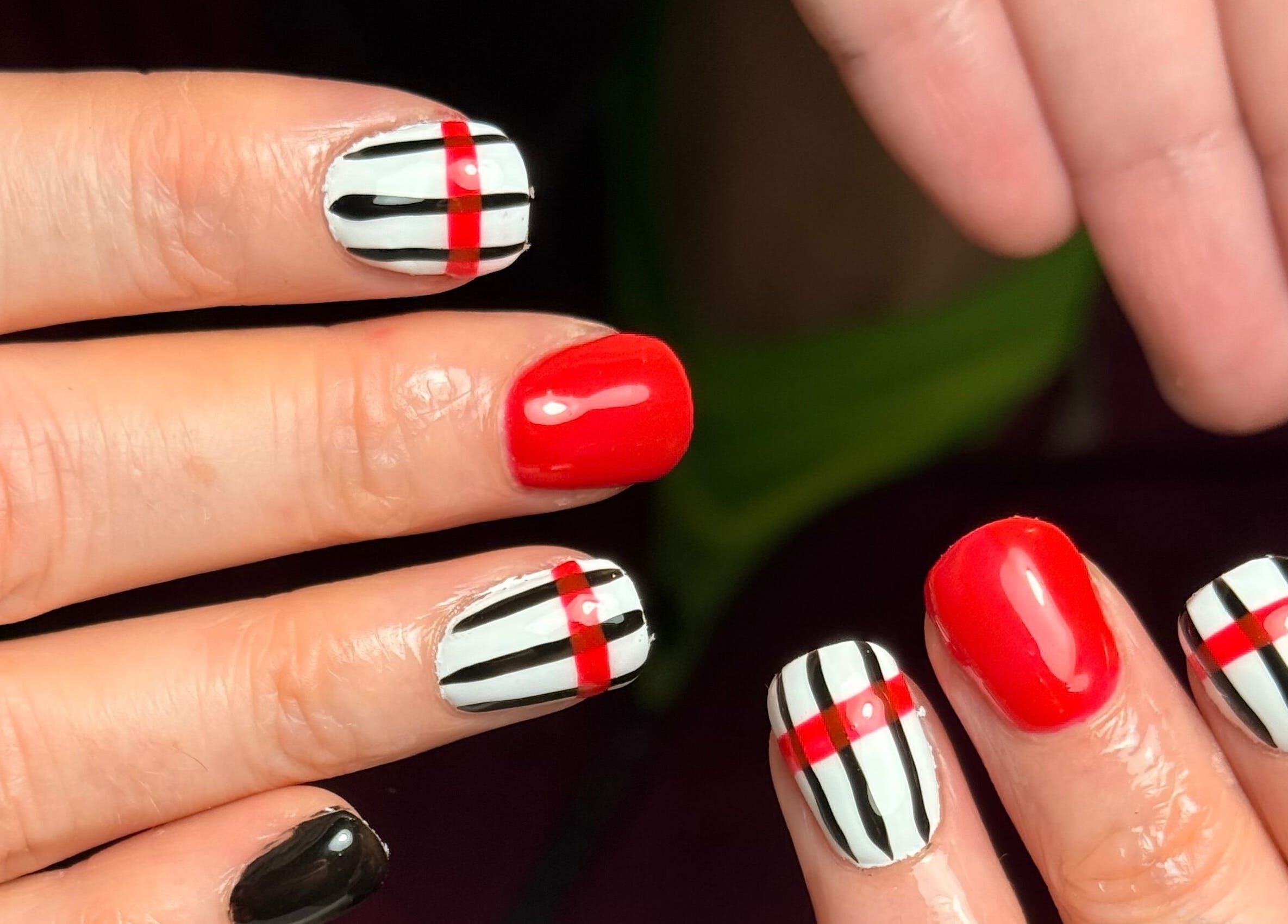Bold red and black striped manicures at naileditbyjadee, Barnoldswick, England, GB.