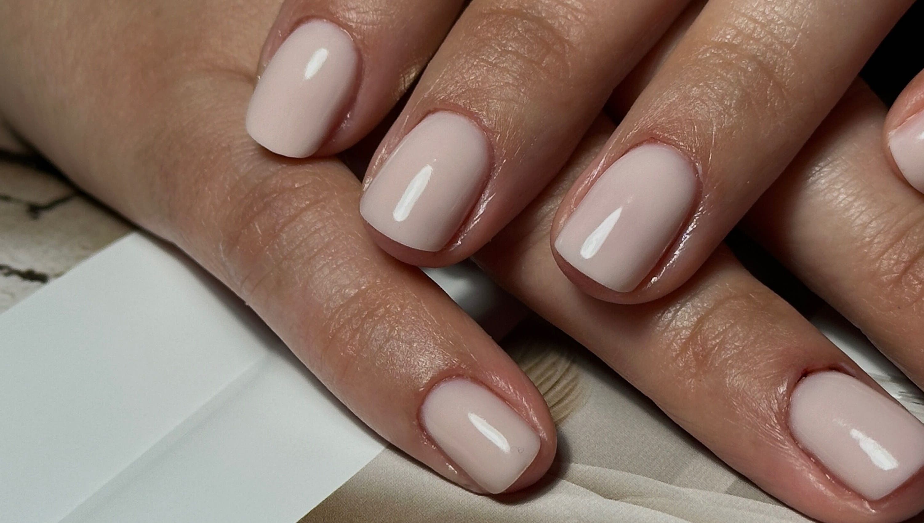 Elegant natural manicure at Glow.by.Angela, London, England, GB. Perfectly groomed hands with a nude finish.