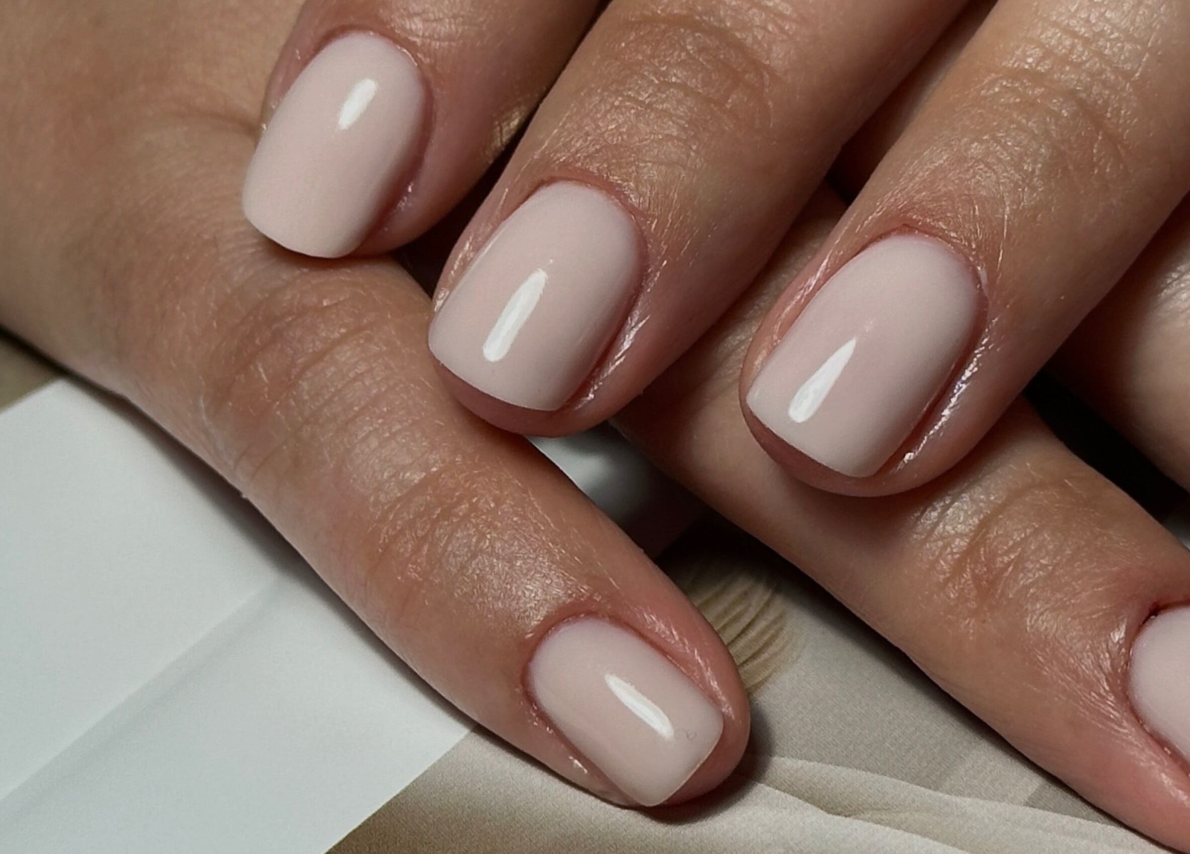 Elegant natural manicure at Glow.by.Angela, London, England, GB. Perfectly groomed hands with a nude finish.