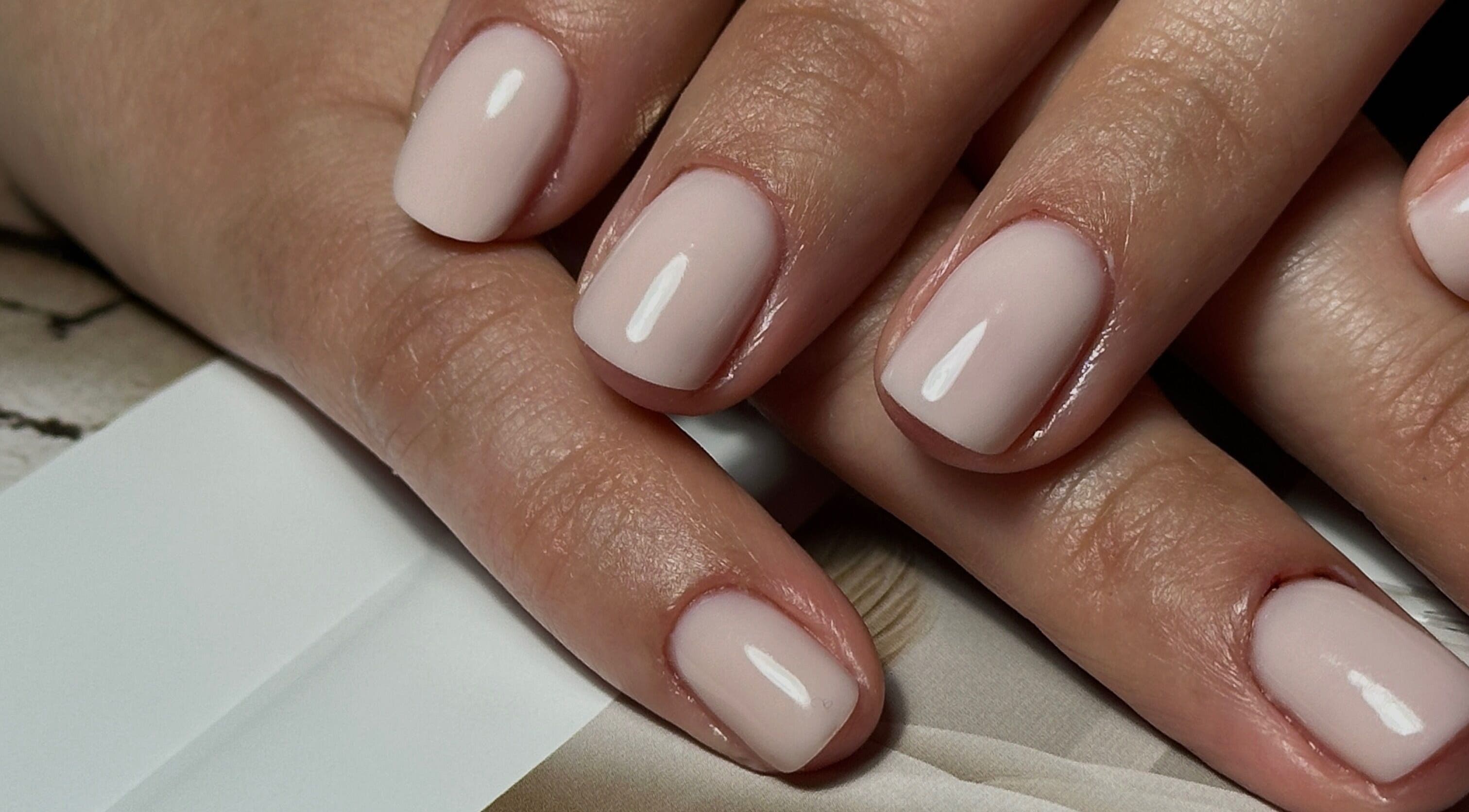 Elegant natural manicure at Glow.by.Angela, London, England, GB. Perfectly groomed hands with a nude finish.
