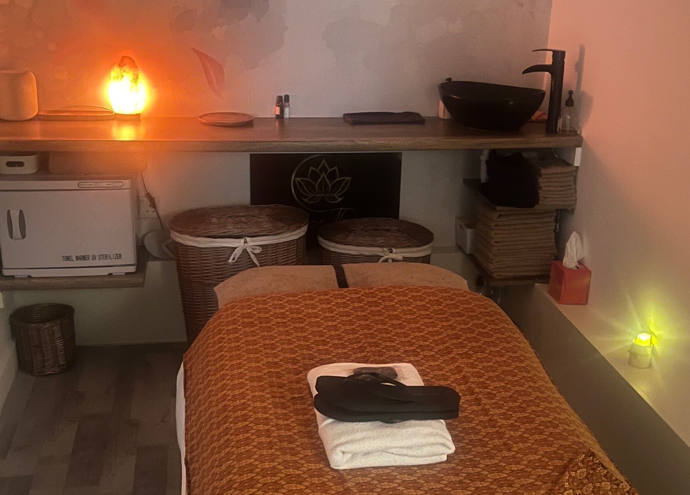 Cozy massage room at Massage Therapy by Maria, London, England, GB with soft lighting and plush linens.