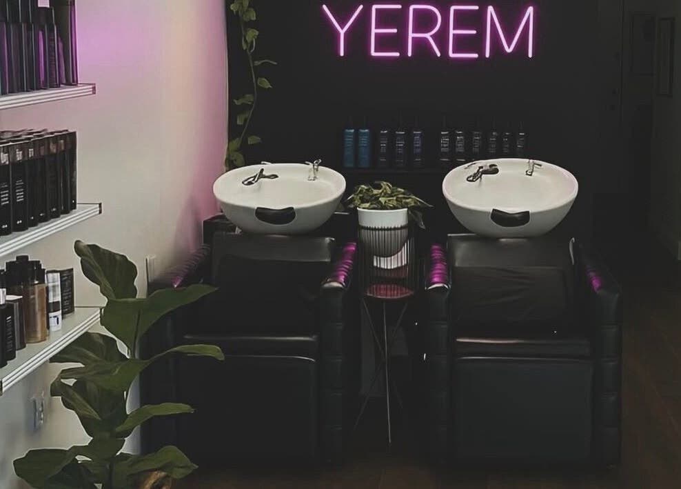 Modern salon wash station at YEREM' in Irvington, New Jersey, US, with sleek design and neon sign.