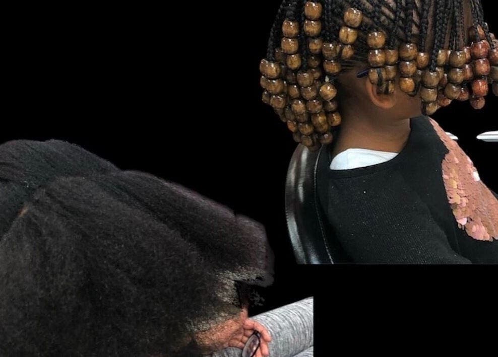 Child with intricate bead-adorned braids at YEREM' salon, Irvington, New Jersey, US.