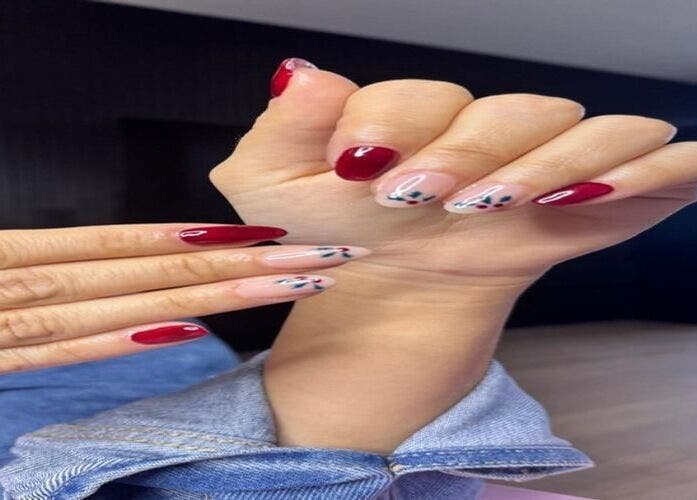 Red and floral nail art displayed at Belle in Ciudad de Mexico, Ciudad De México, MX.