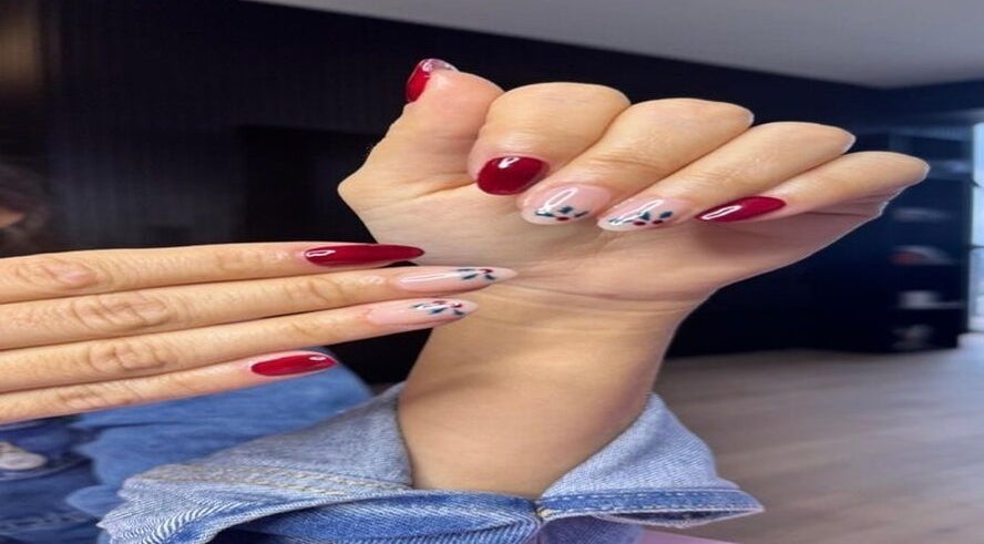 Red and floral nail art displayed at Belle in Ciudad de Mexico, Ciudad De México, MX.