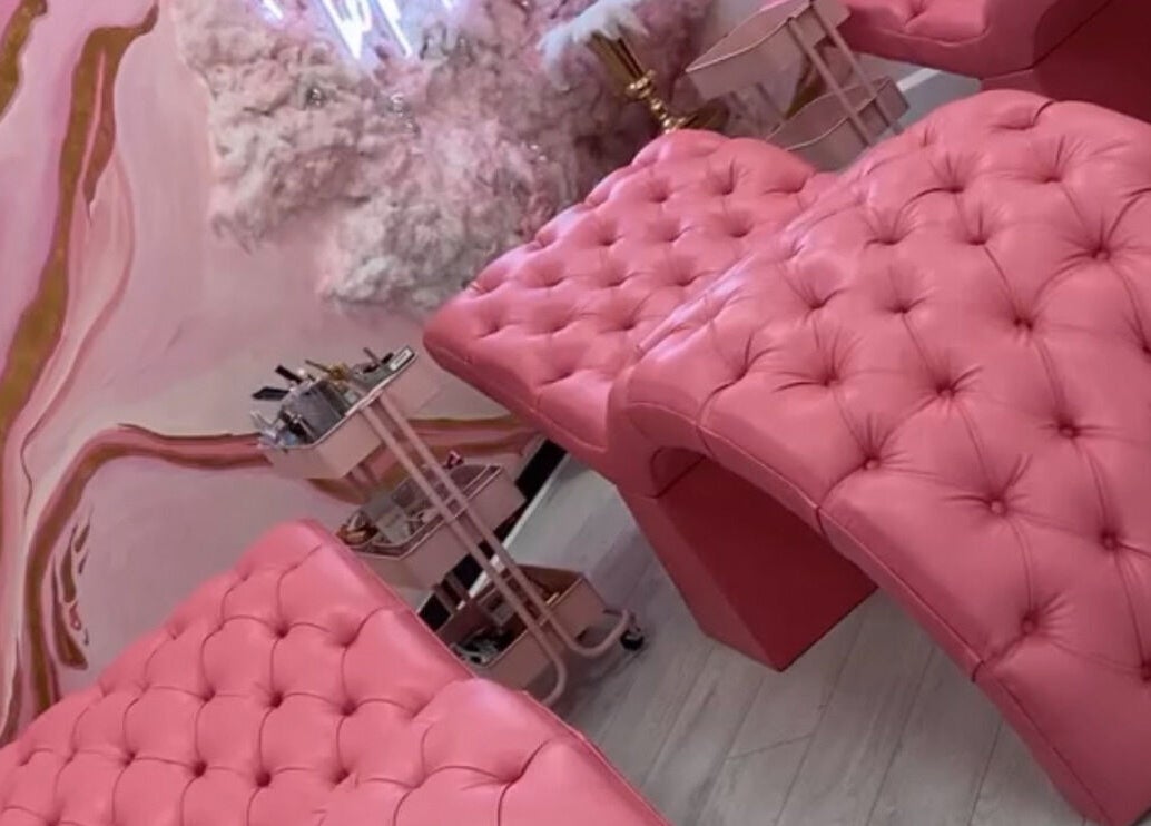 Luxurious pink recliners in Femelle Academy, Manchester, England, GB. Elegant beauty and wellness space.