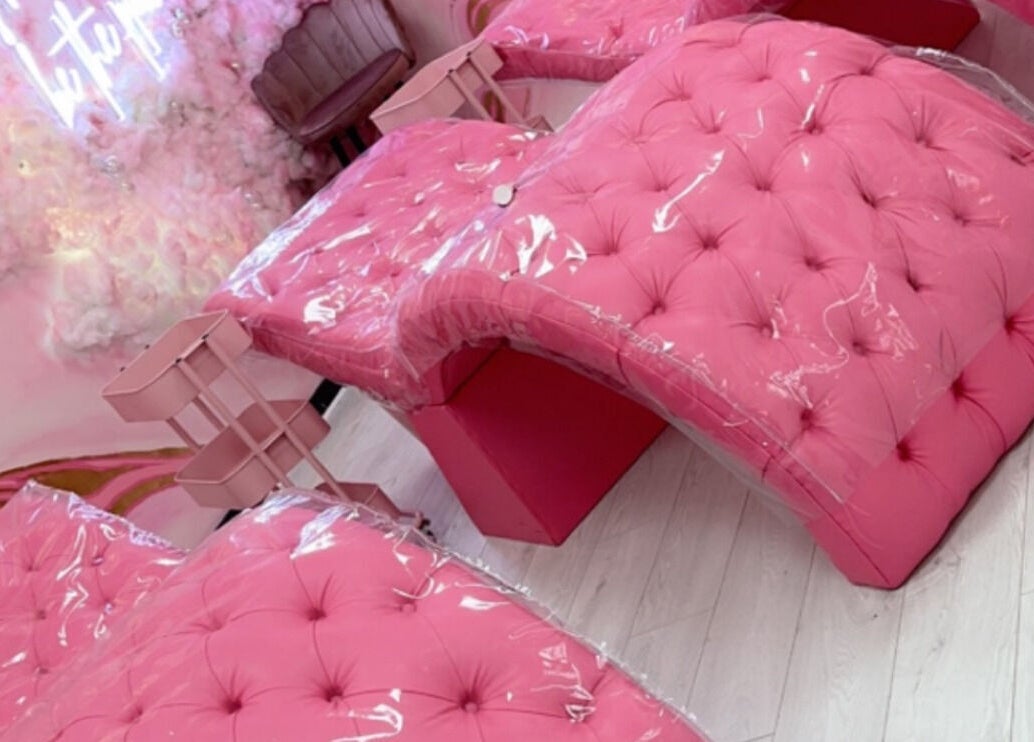 Luxurious pink seating at Femelle Academy, in Manchester, England, GB. Elegant beauty and wellness ambiance.