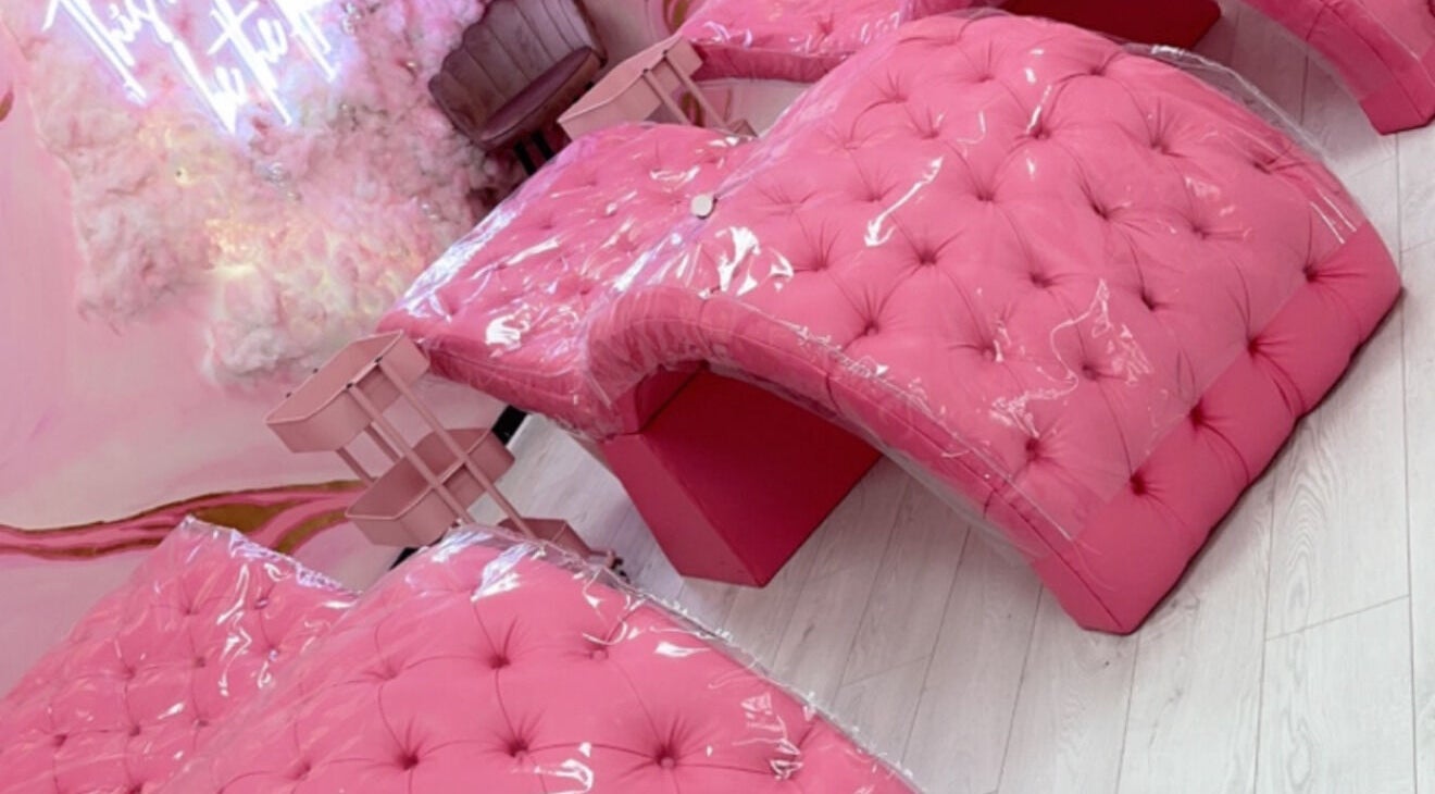 Luxurious pink seating at Femelle Academy, in Manchester, England, GB. Elegant beauty and wellness ambiance.