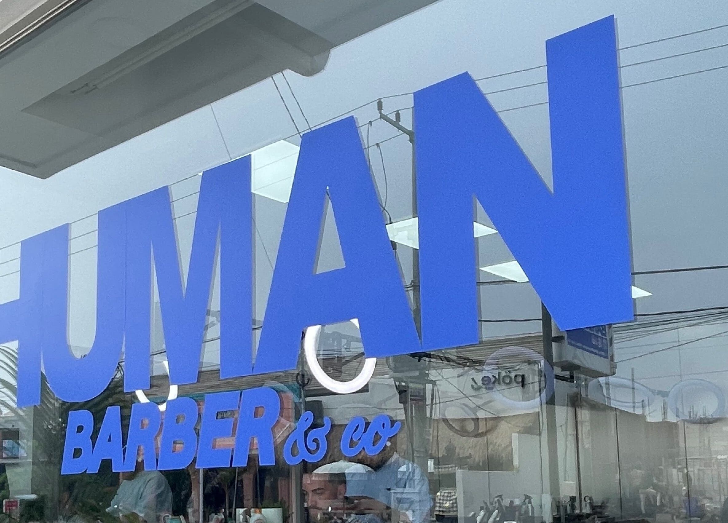 Tampilan depan Human Barber Club VOL 1 di Bali, Bali, ID dengan logo biru cerah.