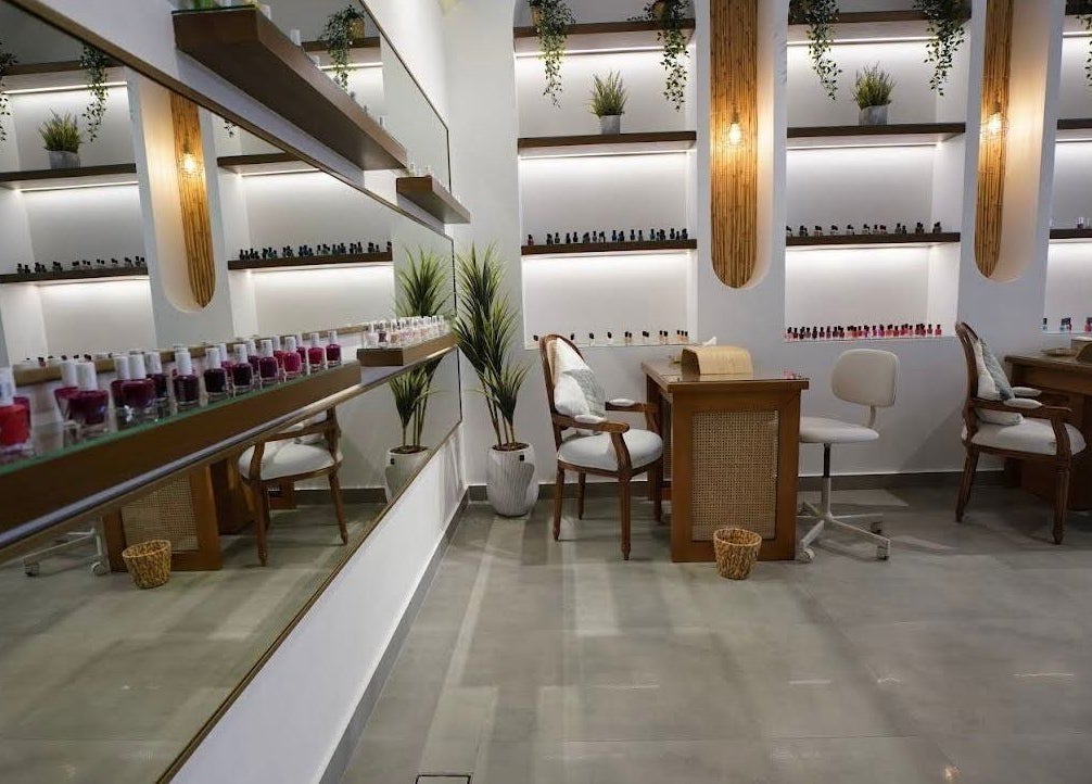 Elegant nail salon interior at Nails Glow- Al Ghadeer, Riyadh, Riyadh Province, SA, showcasing modern decor and polish displays.