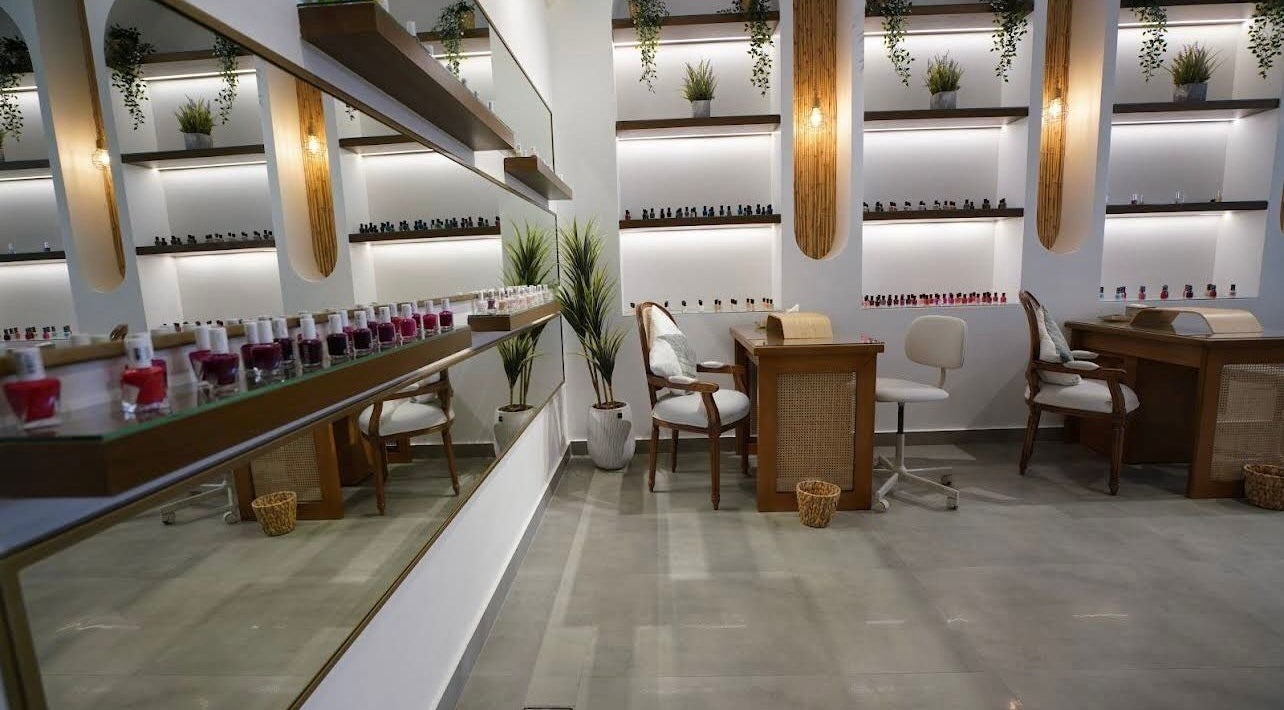 Elegant nail salon interior at Nails Glow- Al Ghadeer, Riyadh, Riyadh Province, SA, showcasing modern decor and polish displays.