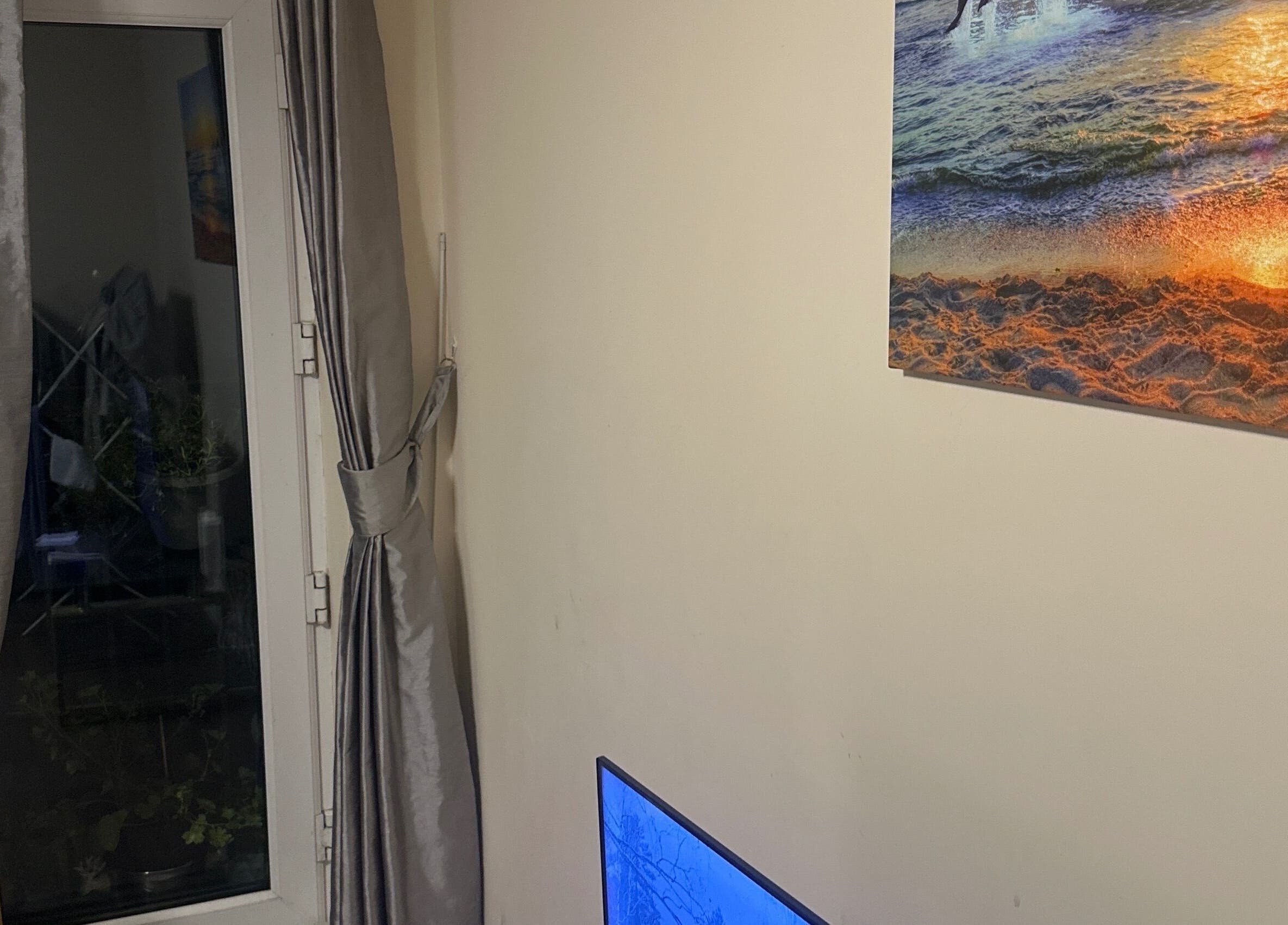 Elegant room with ocean sunset art at GlowLab, Thetford, England, GB, creating a tranquil ambiance.