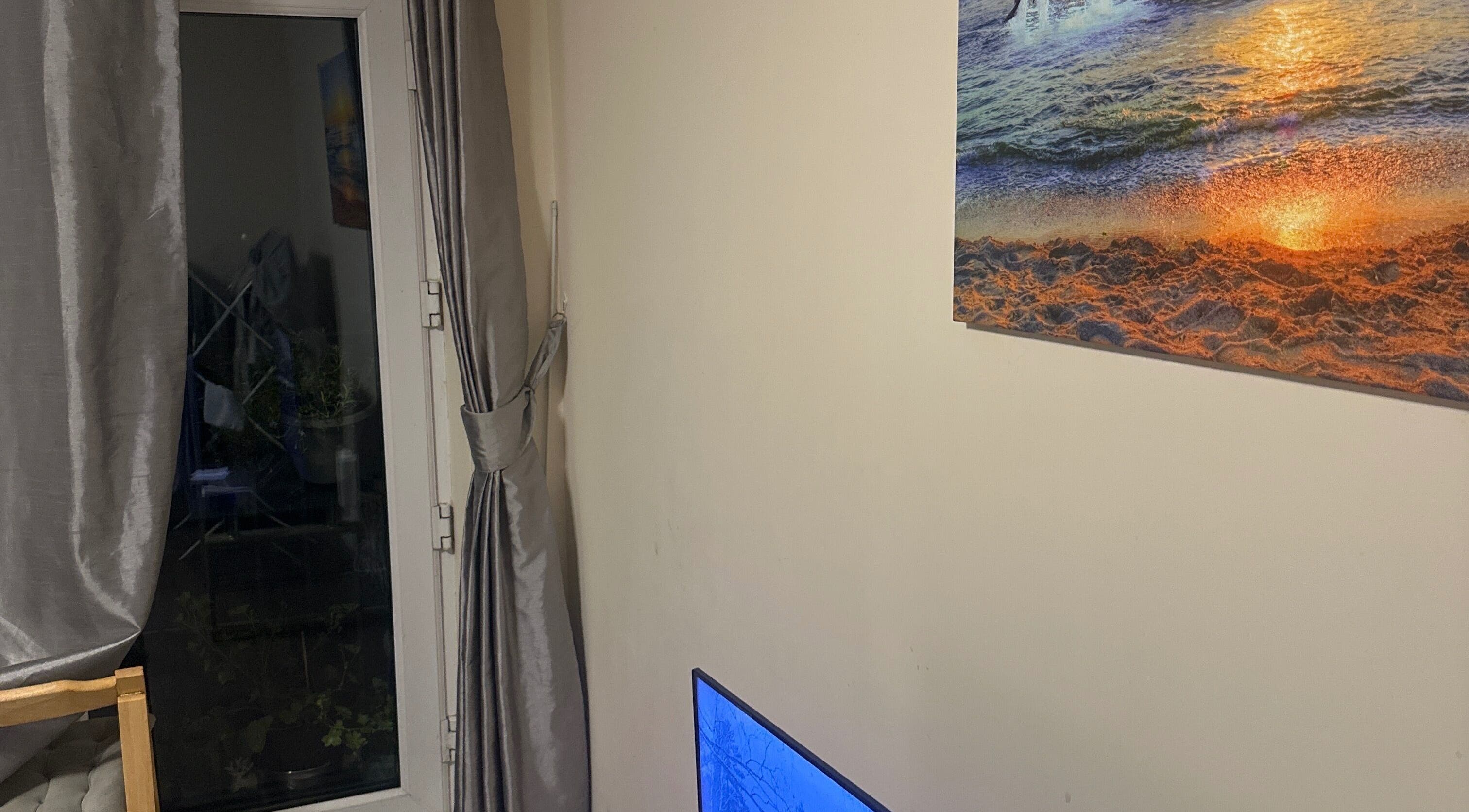 Elegant room with ocean sunset art at GlowLab, Thetford, England, GB, creating a tranquil ambiance.