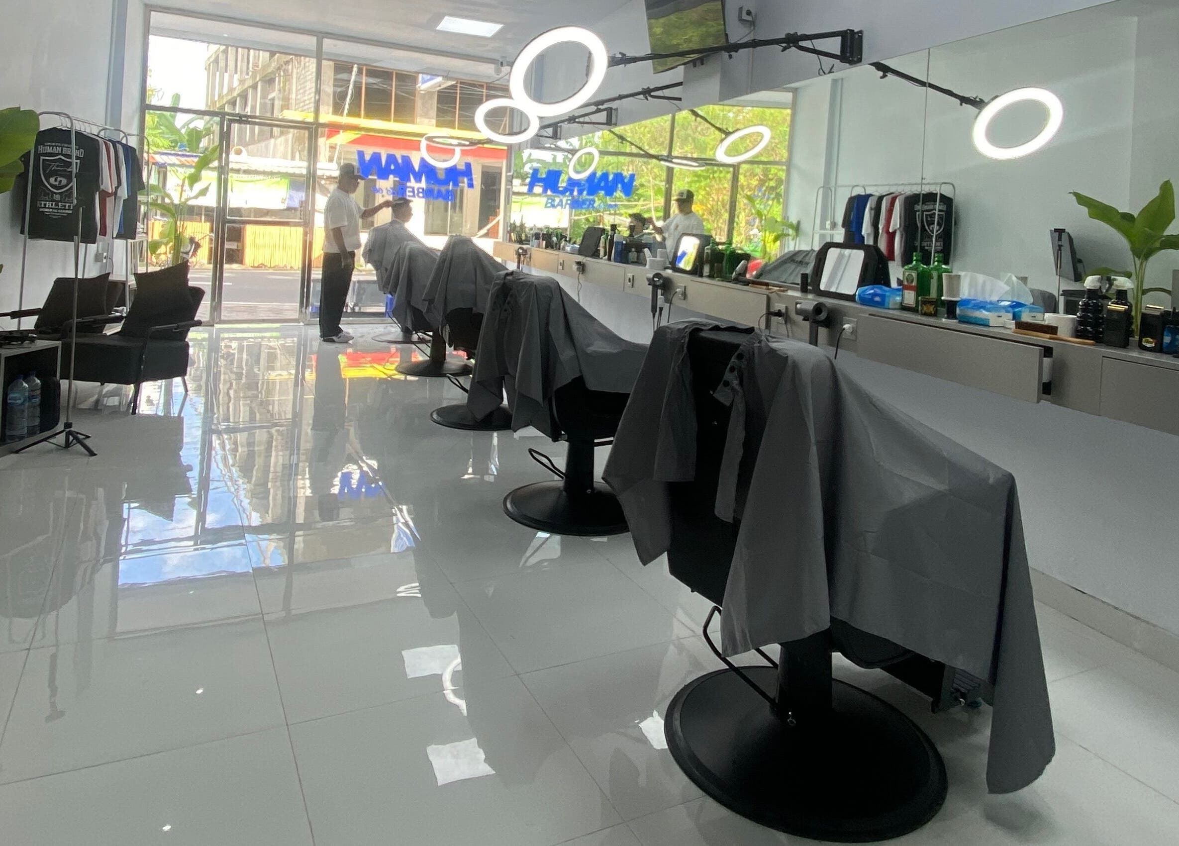 Sleek interior of Human Barber Club Vol 2 in Bali, Bali, ID, with modern styling stations and chairs.