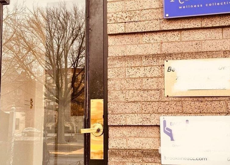 Entrance to Ethereal Path Wellness, brick facade in Brookline, Massachusetts, US.