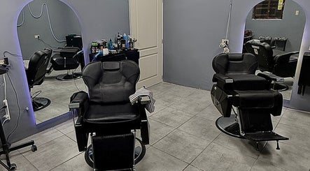 Interior del Mucho Pelo Barber Studio en Juárez, Chihuahua, MX, mostrando sillones de barbería modernos.