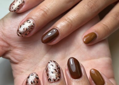 Stylish nail art at Beauty Box Spa in Bracknell, England, GB showcasing chic brown and glitter designs.