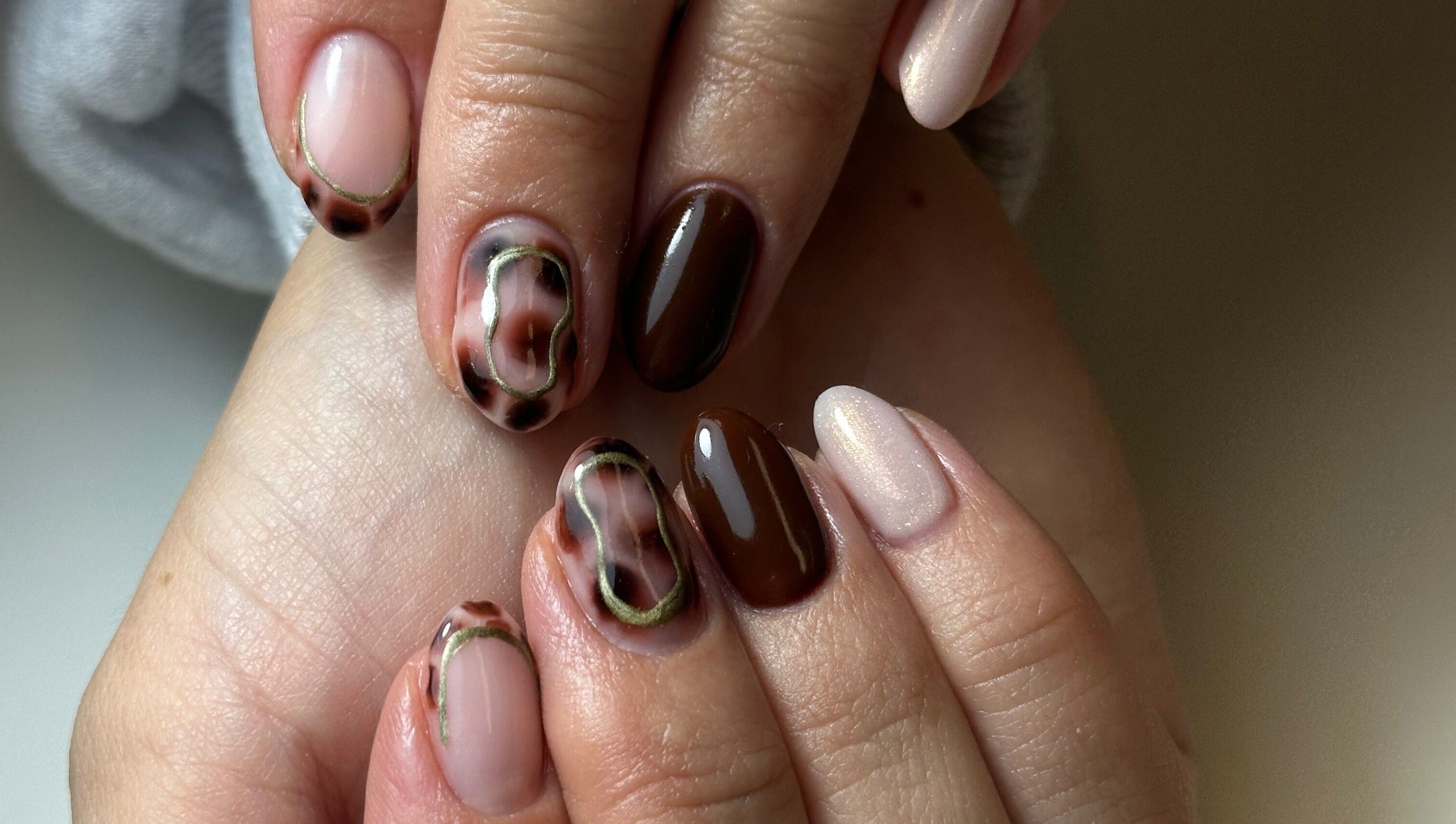 Stylish nail art featuring brown and beige tones at Beauty Box Spa, Bracknell, England, GB.