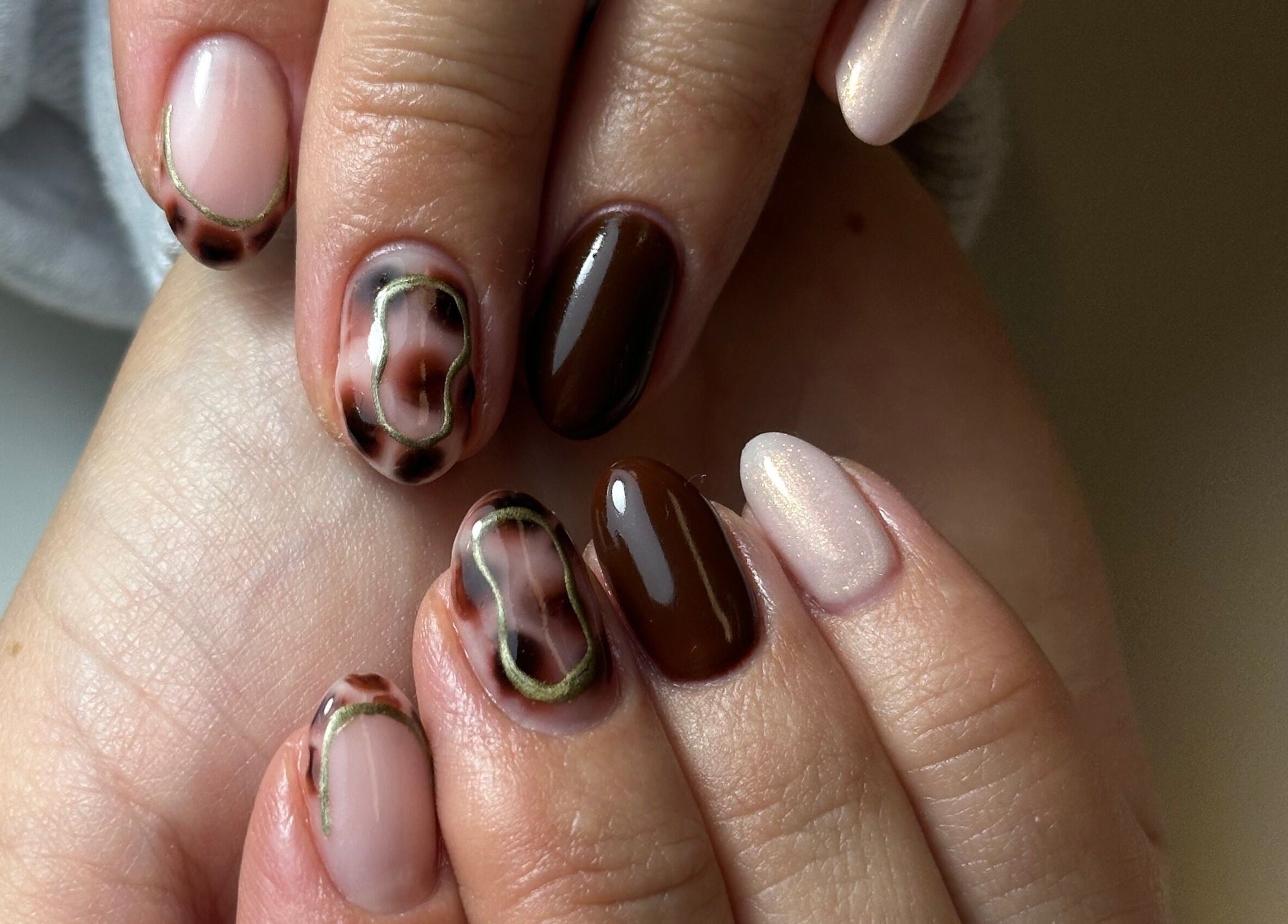 Stylish nail art featuring brown and beige tones at Beauty Box Spa, Bracknell, England, GB.