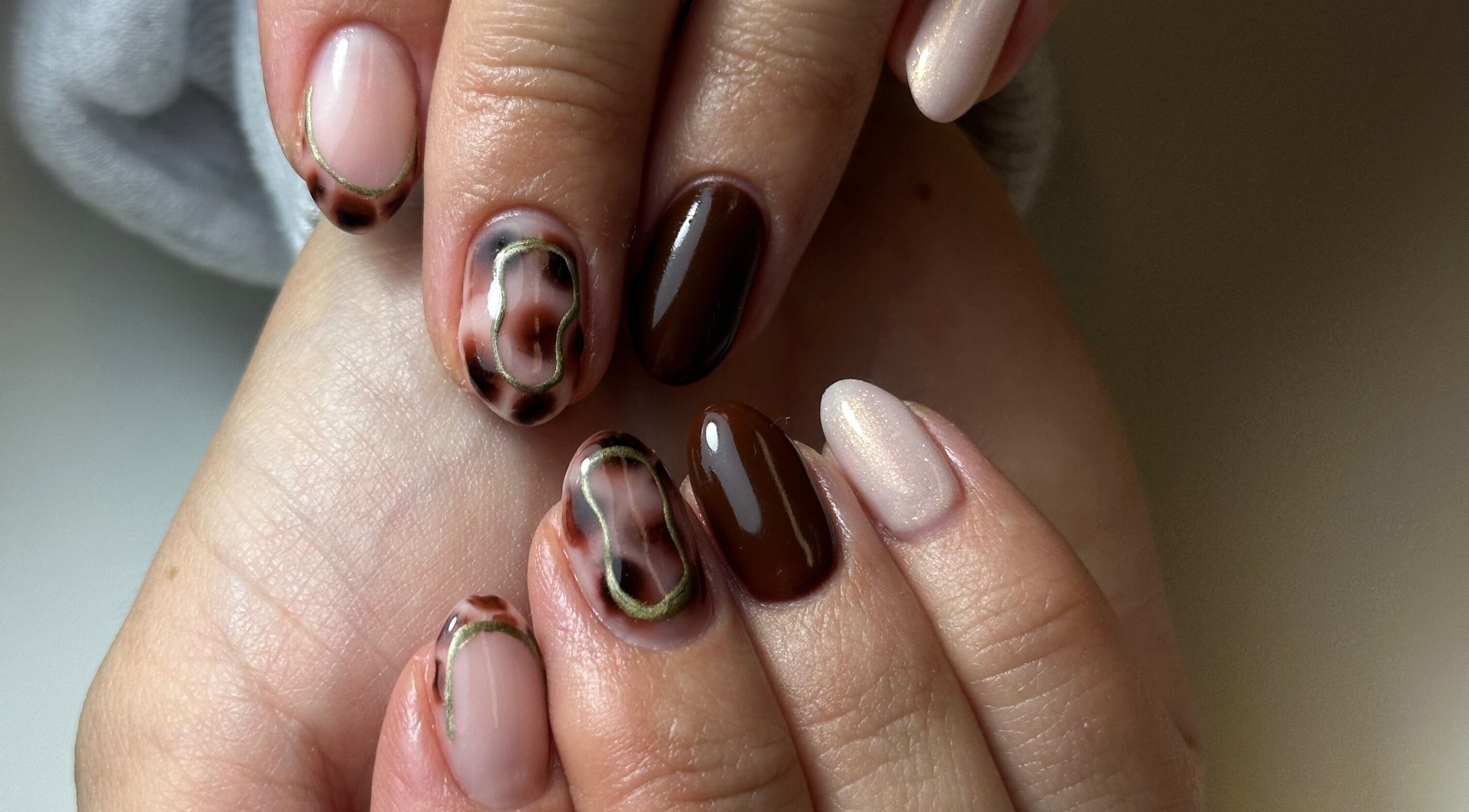 Stylish nail art featuring brown and beige tones at Beauty Box Spa, Bracknell, England, GB.