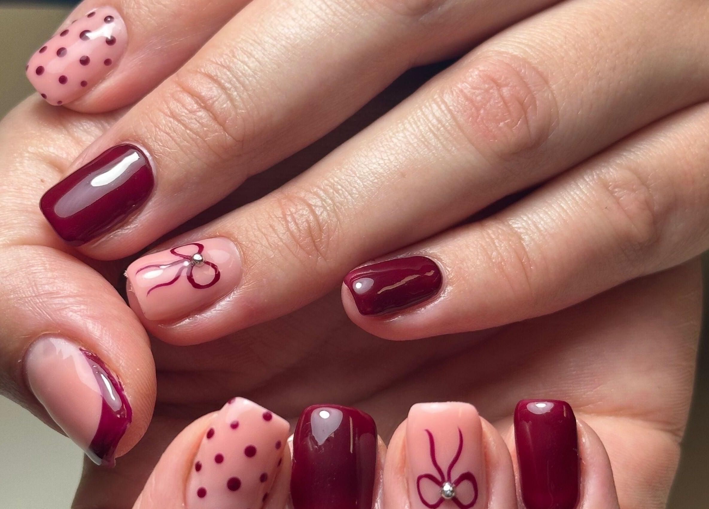 Beautiful nail art in red and pink hues at Beauty Box Spa, Bracknell, England, GB.