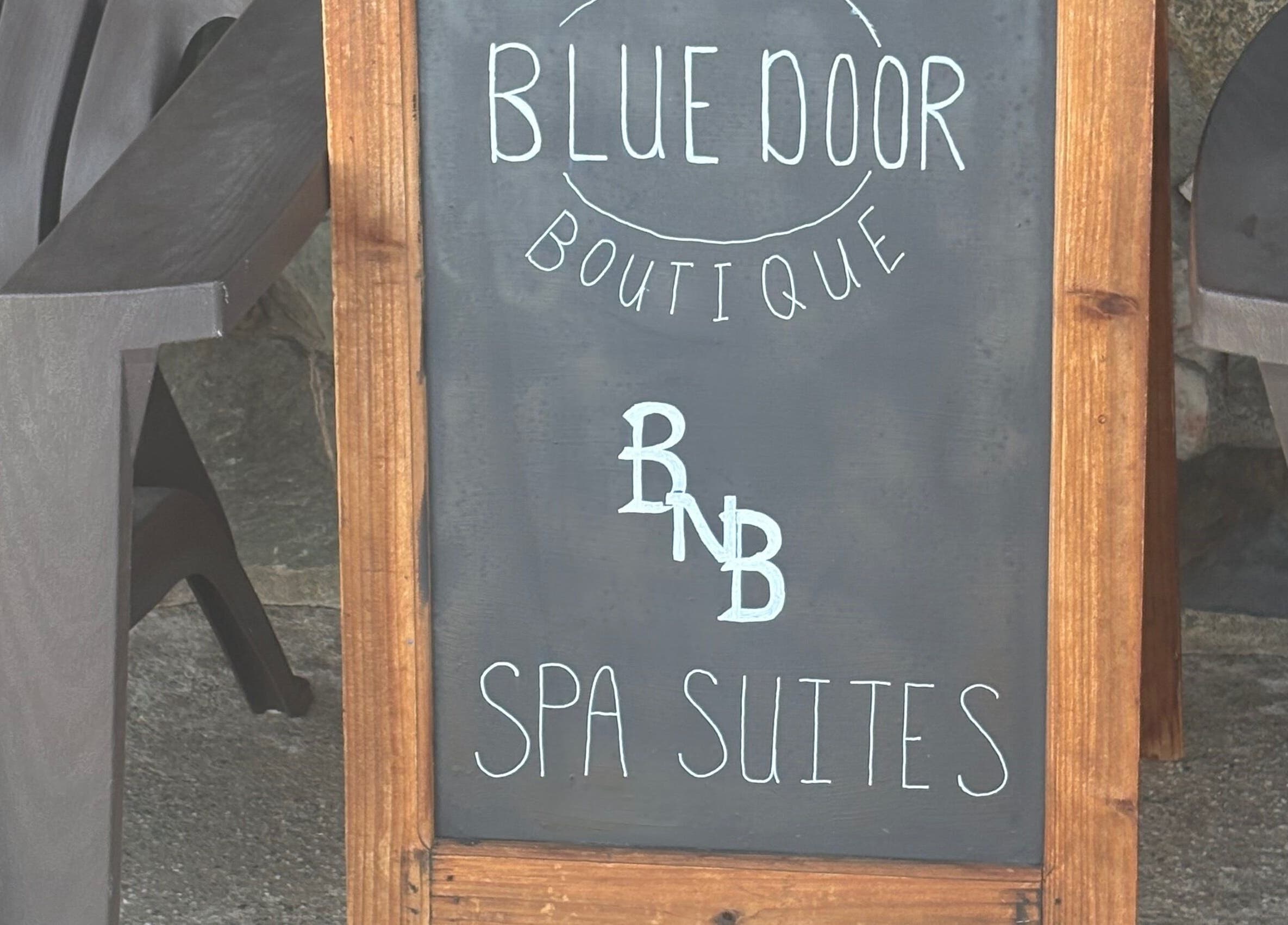 Blue Door Boutique spa sign near Glow Connection in Loomis, California, US offers serene spa suites.