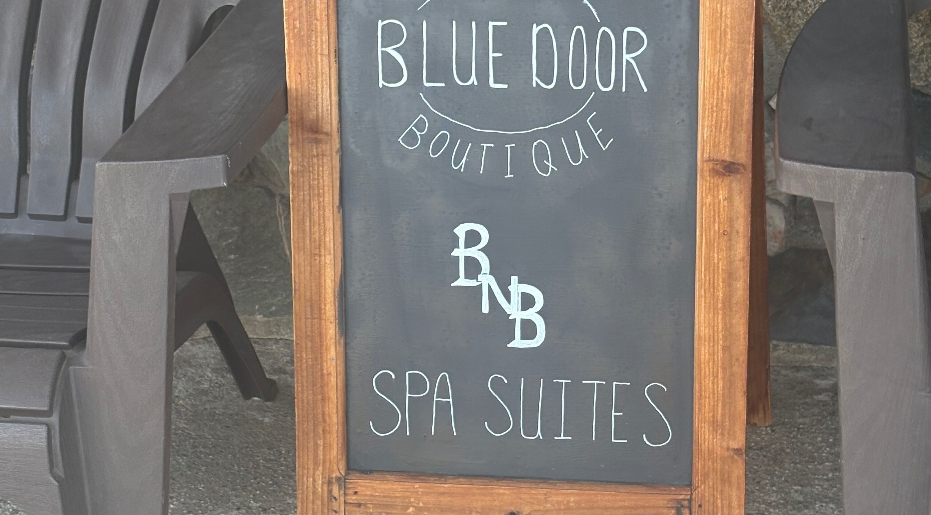 Blue Door Boutique spa sign near Glow Connection in Loomis, California, US offers serene spa suites.