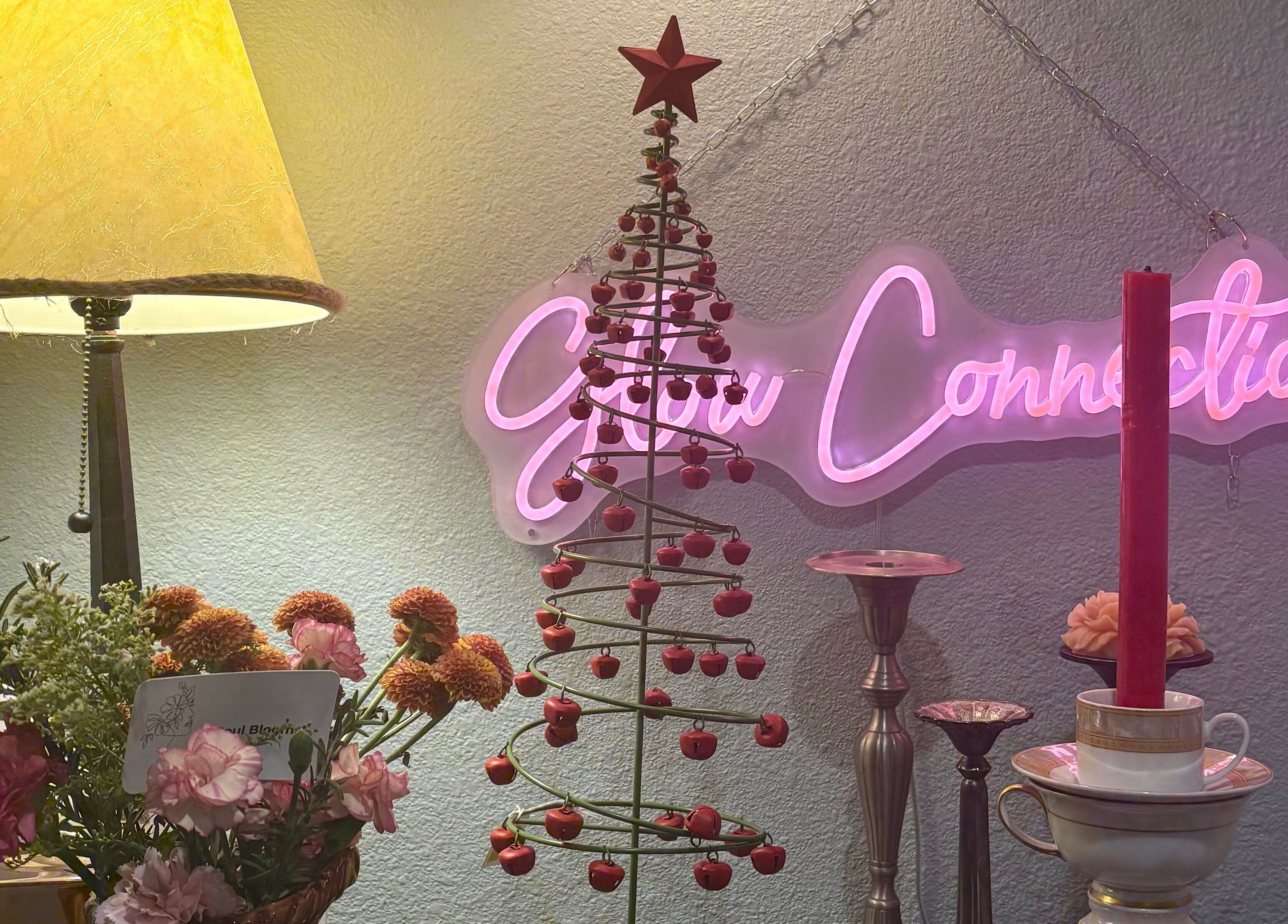Festive decor at Glow Connection, Loomis, California, US featuring a neon sign and holiday accents.