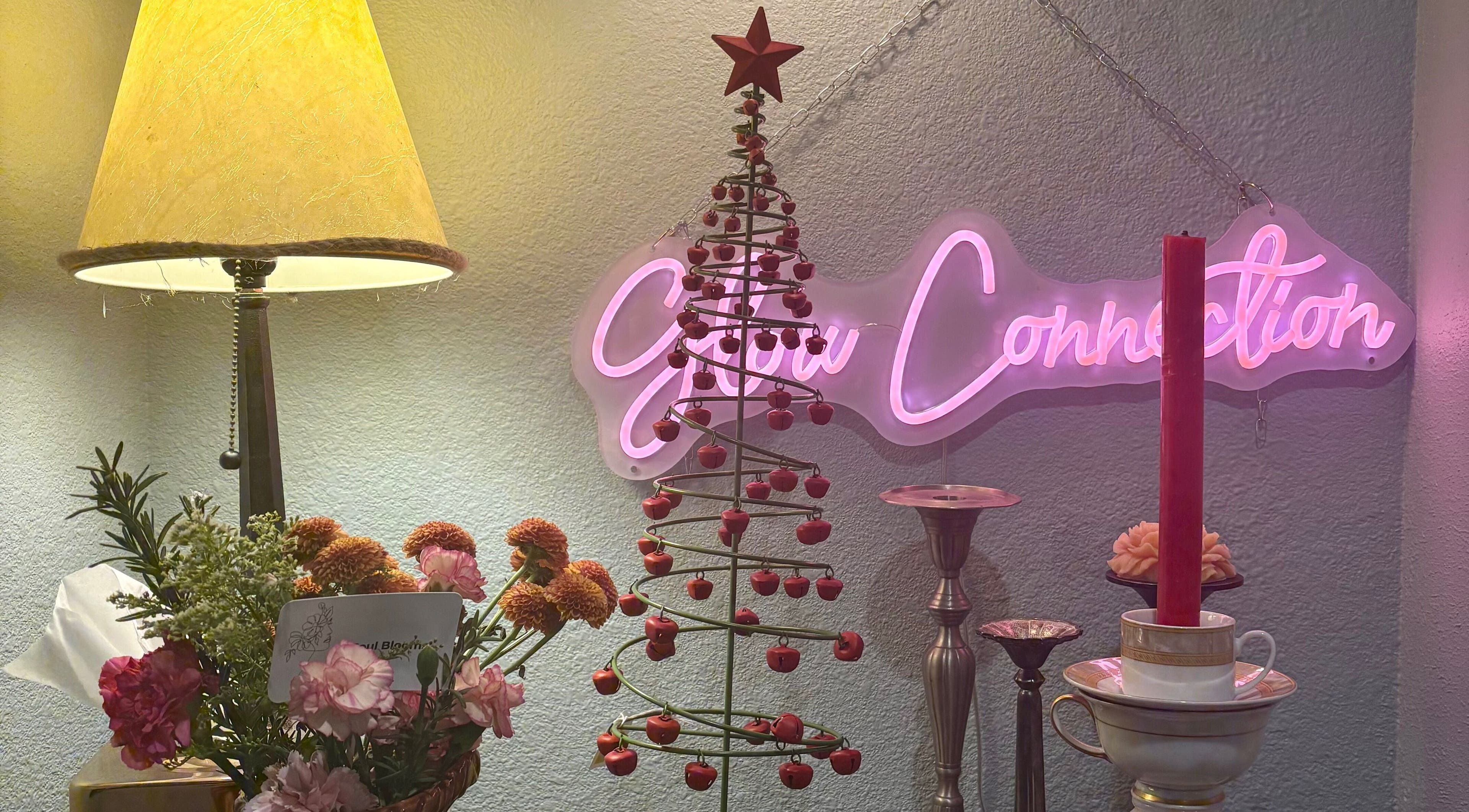 Festive decor at Glow Connection, Loomis, California, US featuring a neon sign and holiday accents.