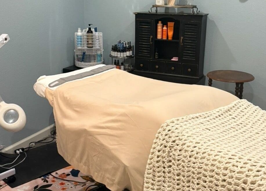 Tranquil treatment room at Glow Connection, Loomis, California, US, featuring a cozy bed and ambient decor.