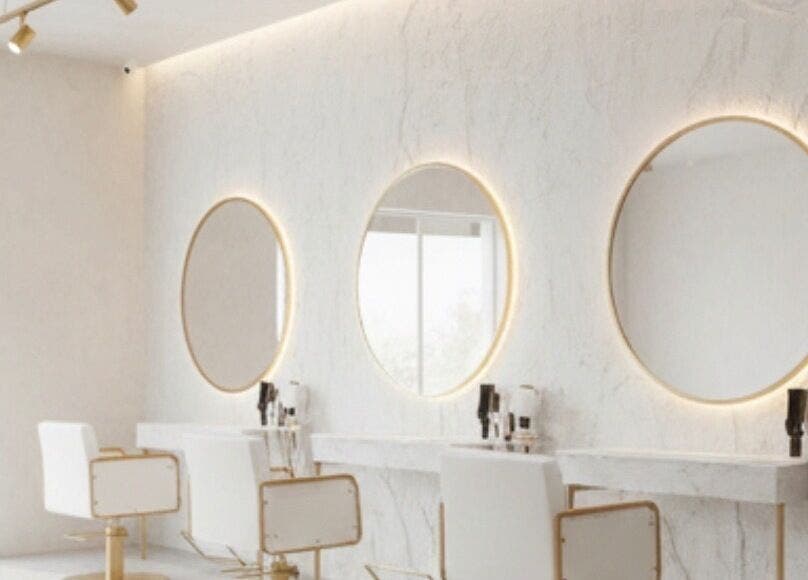 Modern styling stations at Dajore Hair, Freeport, BS with elegant mirrors and chic lighting.
