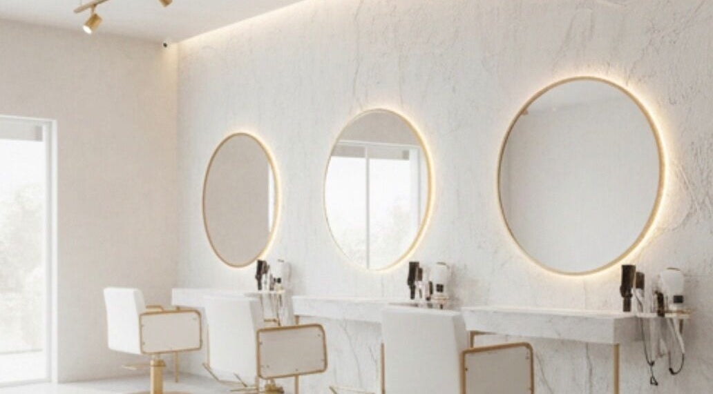 Modern styling stations at Dajore Hair, Freeport, BS with elegant mirrors and chic lighting.