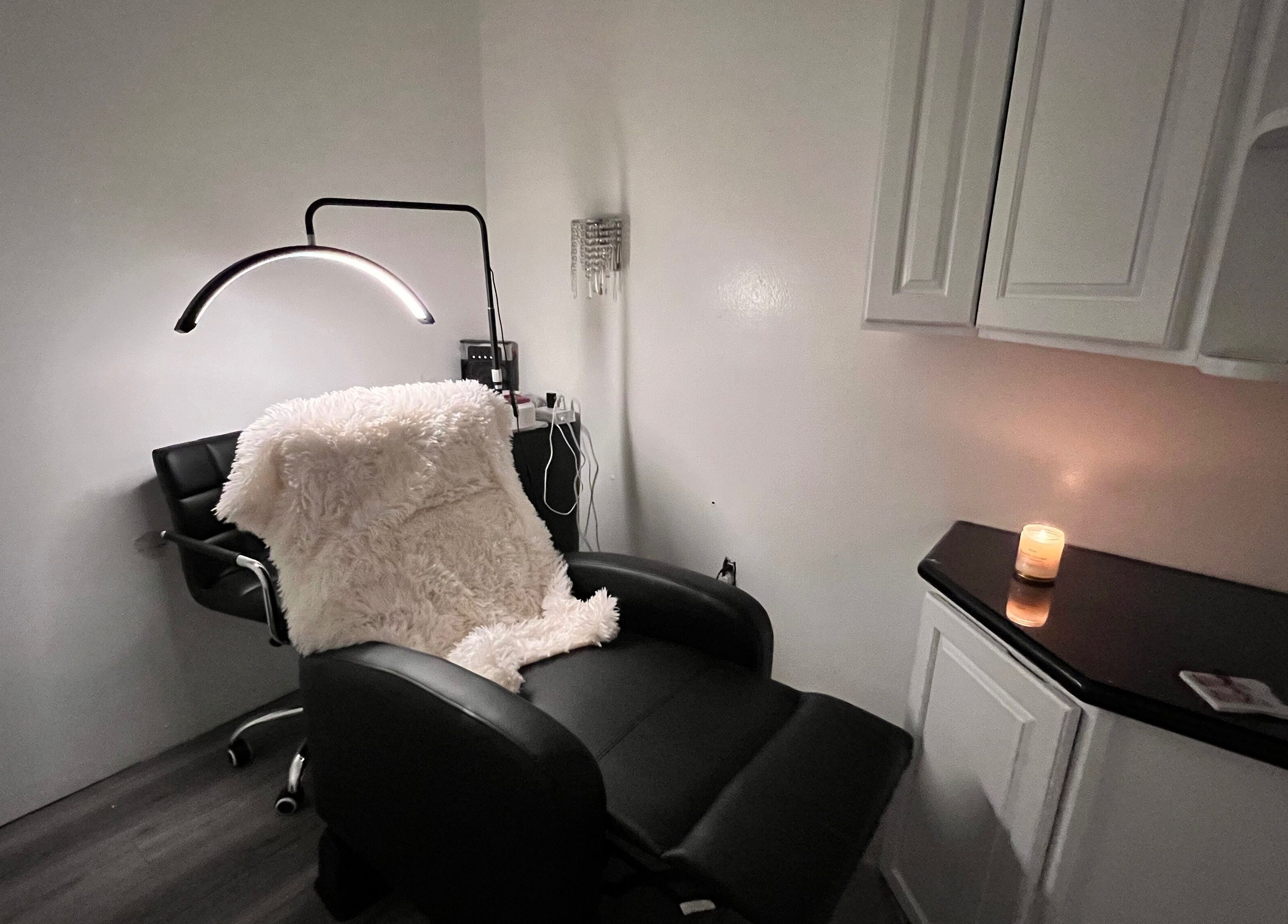 Relaxing treatment chair and candlelit ambiance at Carli Brow Lab, Lowell, Massachusetts, US.