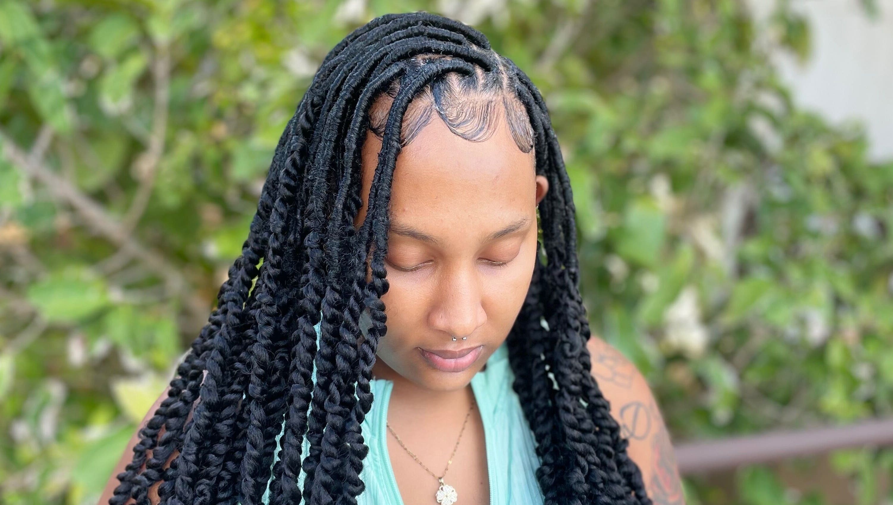 Woman with intricate braids styled at Kyng’s Hair Care, Saint John's, Saint John, AG.