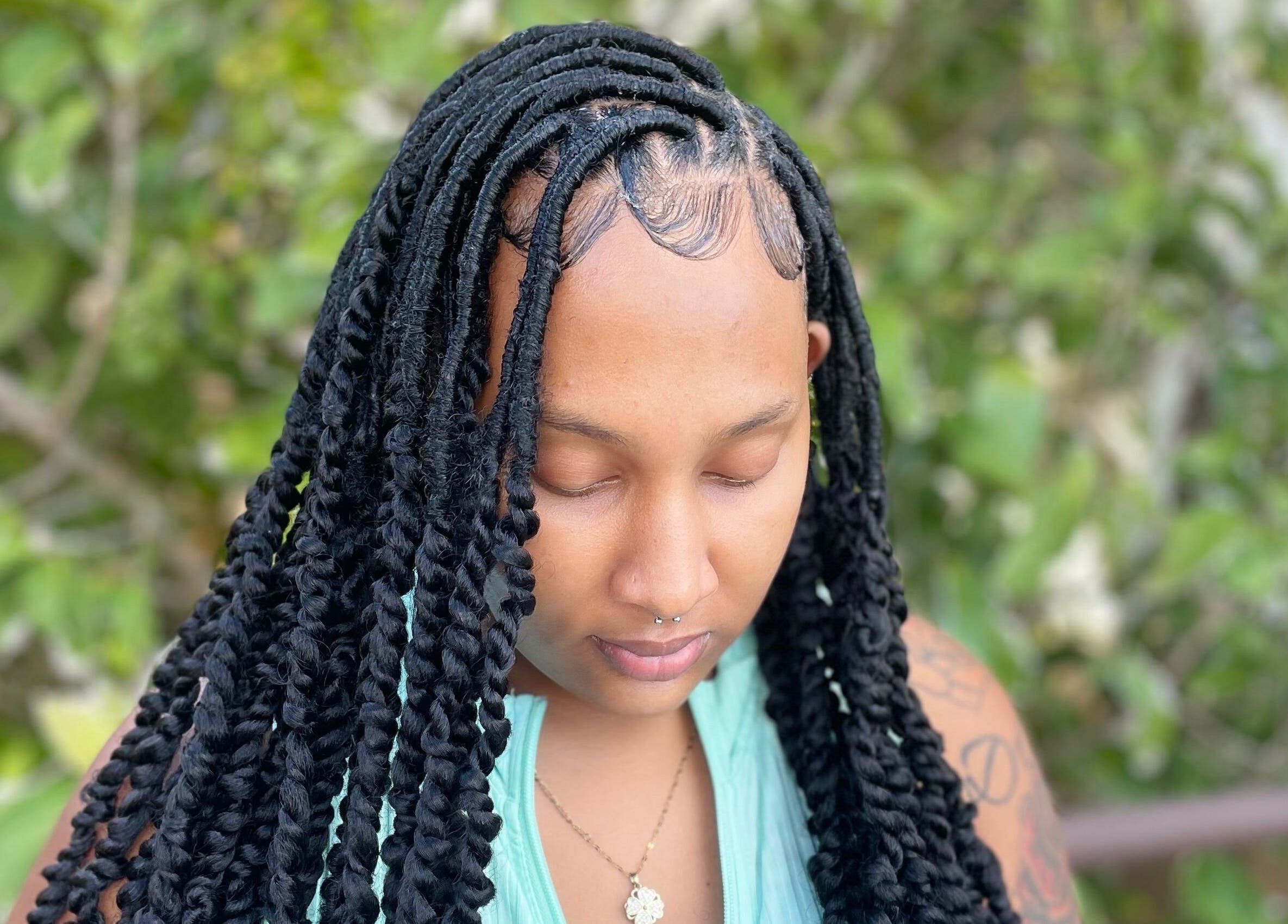 Woman with intricate braids styled at Kyng’s Hair Care, Saint John's, Saint John, AG.