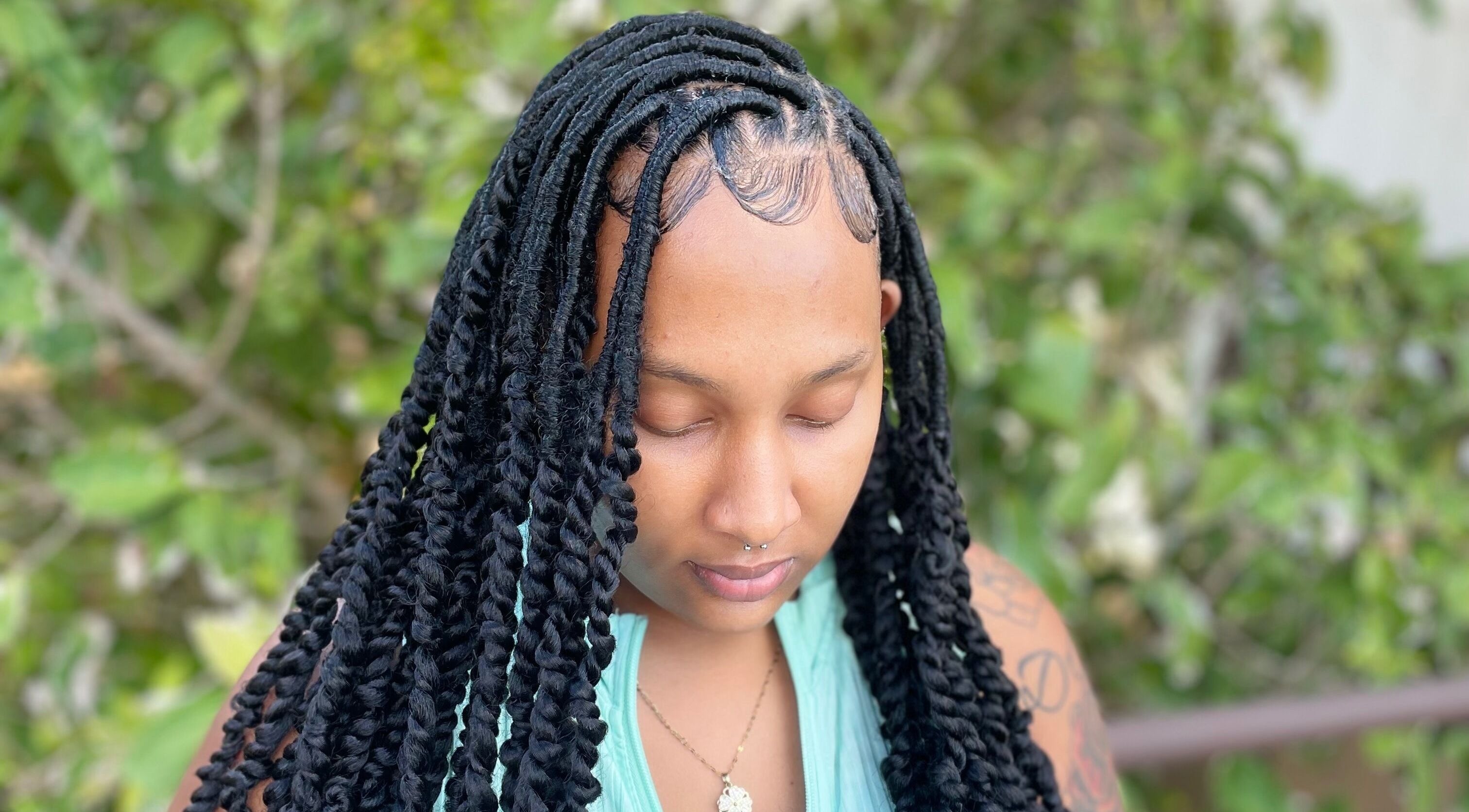 Woman with intricate braids styled at Kyng’s Hair Care, Saint John's, Saint John, AG.