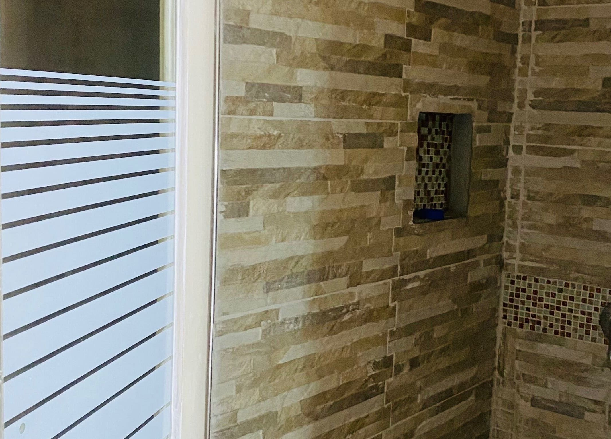 Elegant stone-tiled shower at Healing Emerald Wellness Spa & Training Centre Ltd, Kingston, St. Andrew Parish, JM.