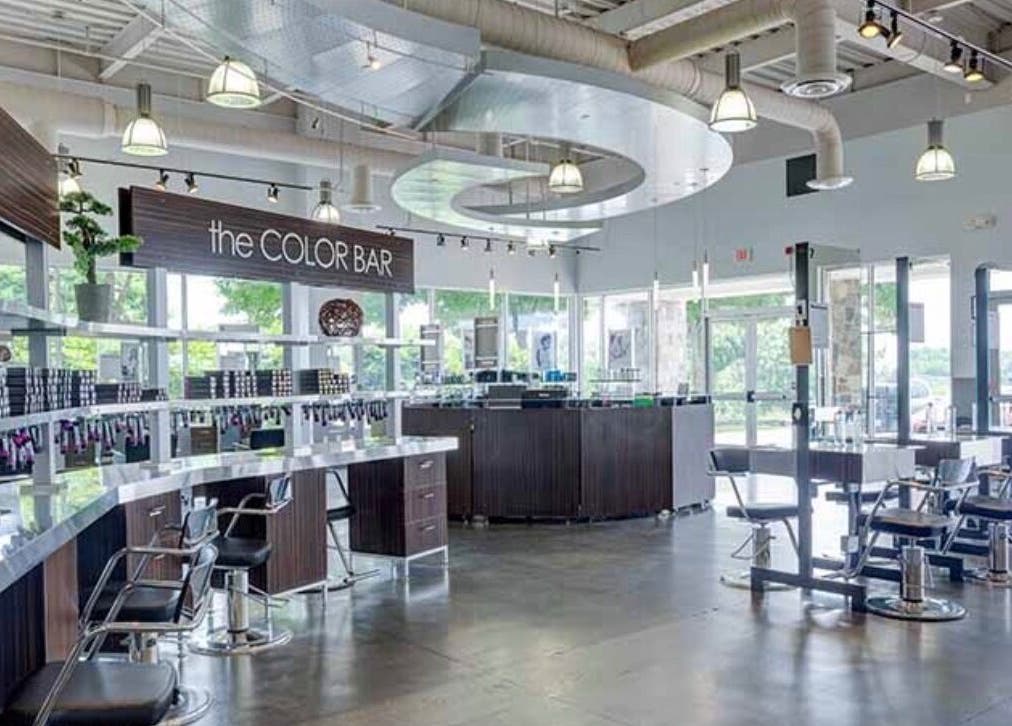 Modern salon interior at LOURDEZ DOES HAIR, Cranston, Rhode Island, US, showcasing sleek, stylish seating.