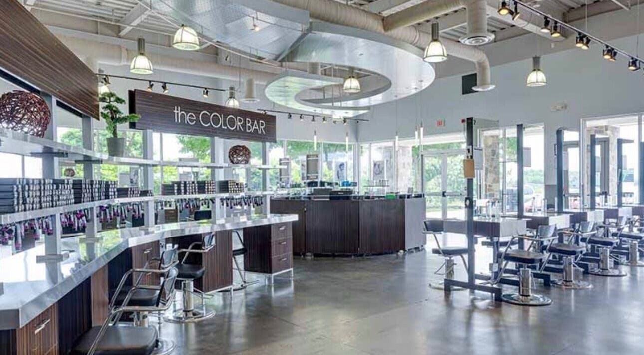 Modern salon interior at LOURDEZ DOES HAIR, Cranston, Rhode Island, US, showcasing sleek, stylish seating.
