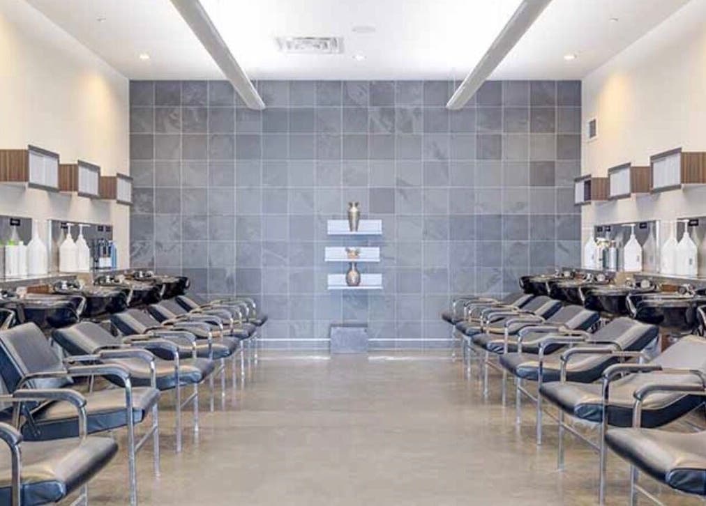 Modern salon interior of LOURDEZ DOES HAIR in Cranston, Rhode Island, US with sleek chairs and wash stations.