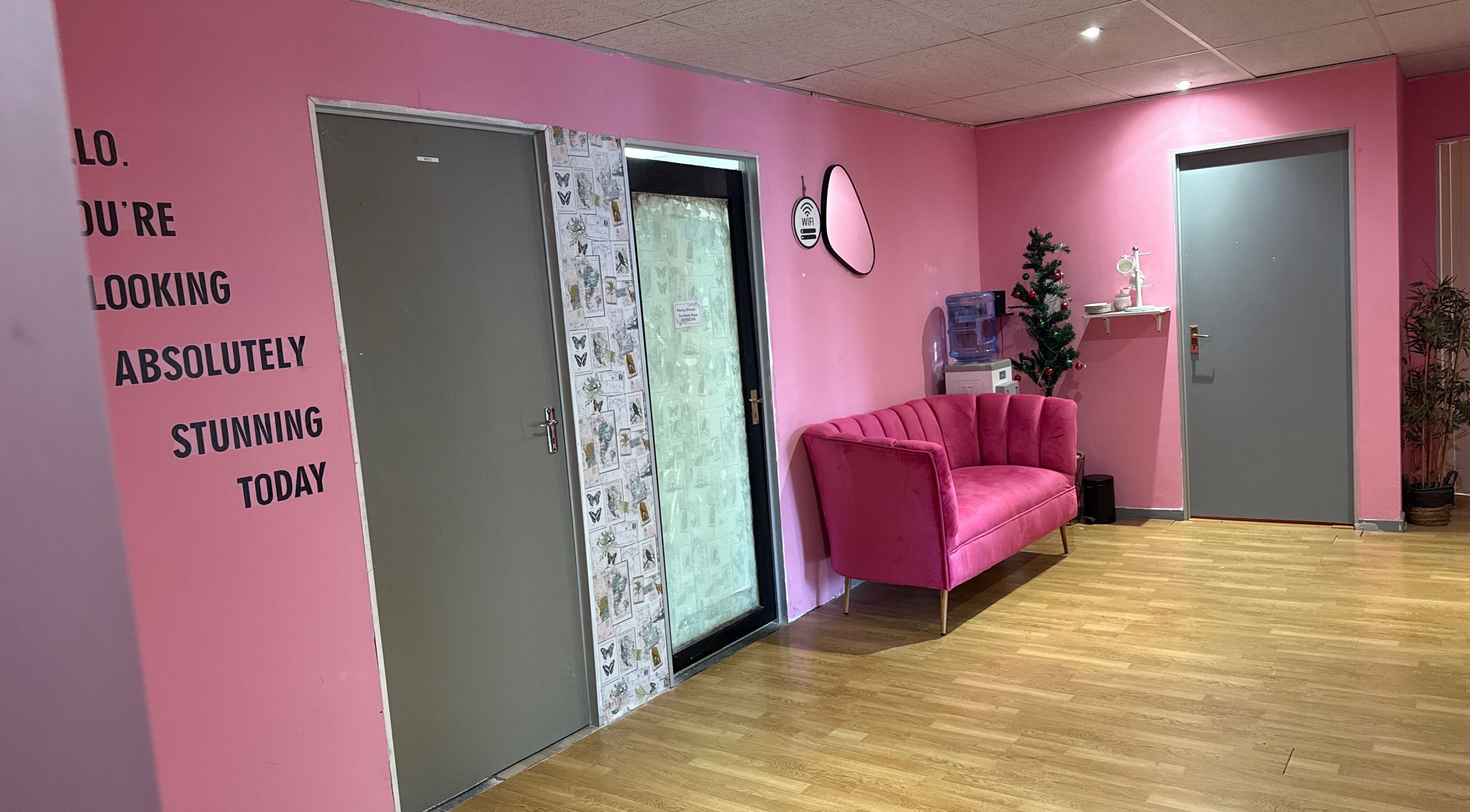 Bright pink lounge at Niceglamebynicole, Randburg, Gauteng, ZA with modern decor and inviting seating.