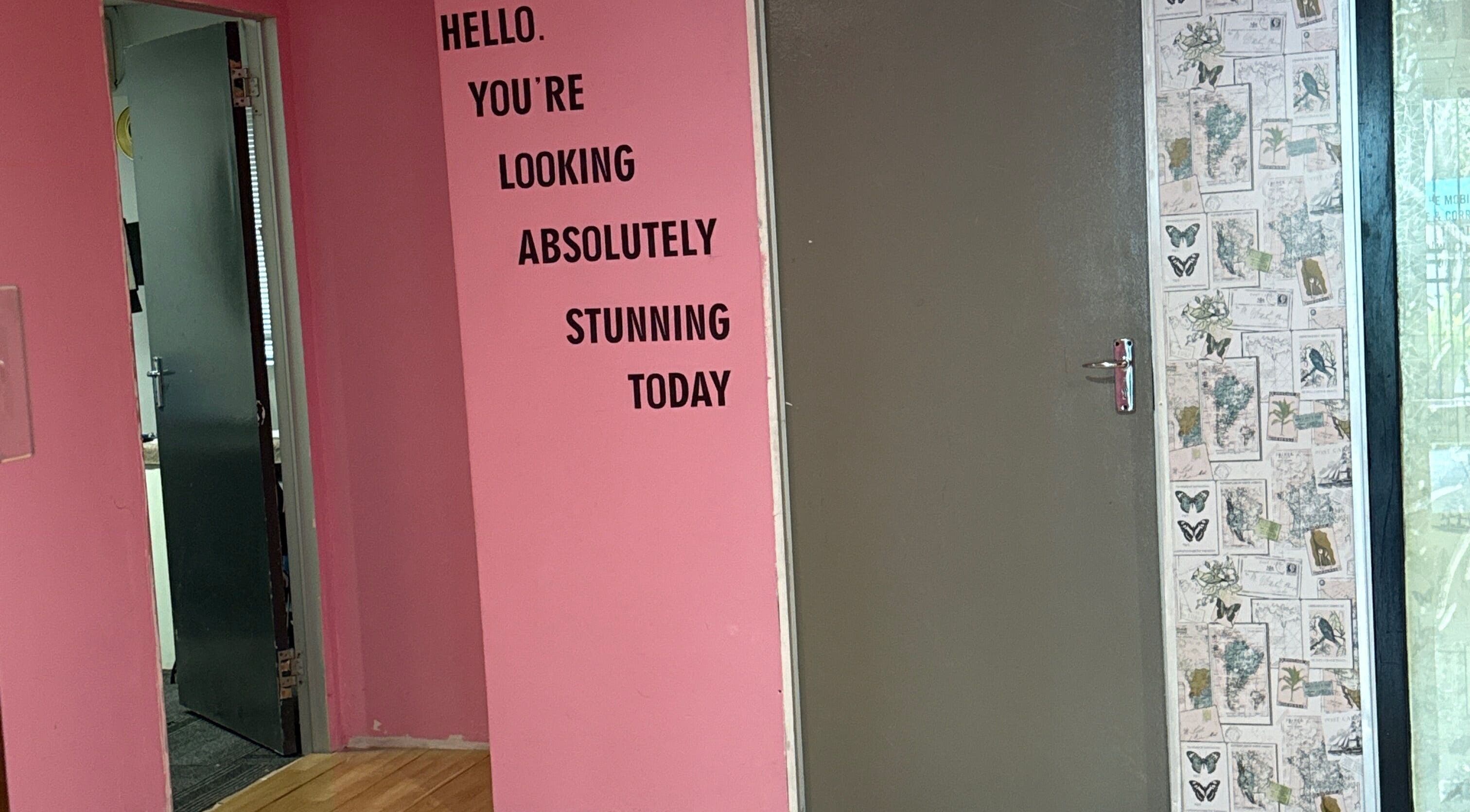 Pink wall with motivational text at Niceglamebynicole, Randburg, Gauteng, ZA, creating a welcoming ambiance.