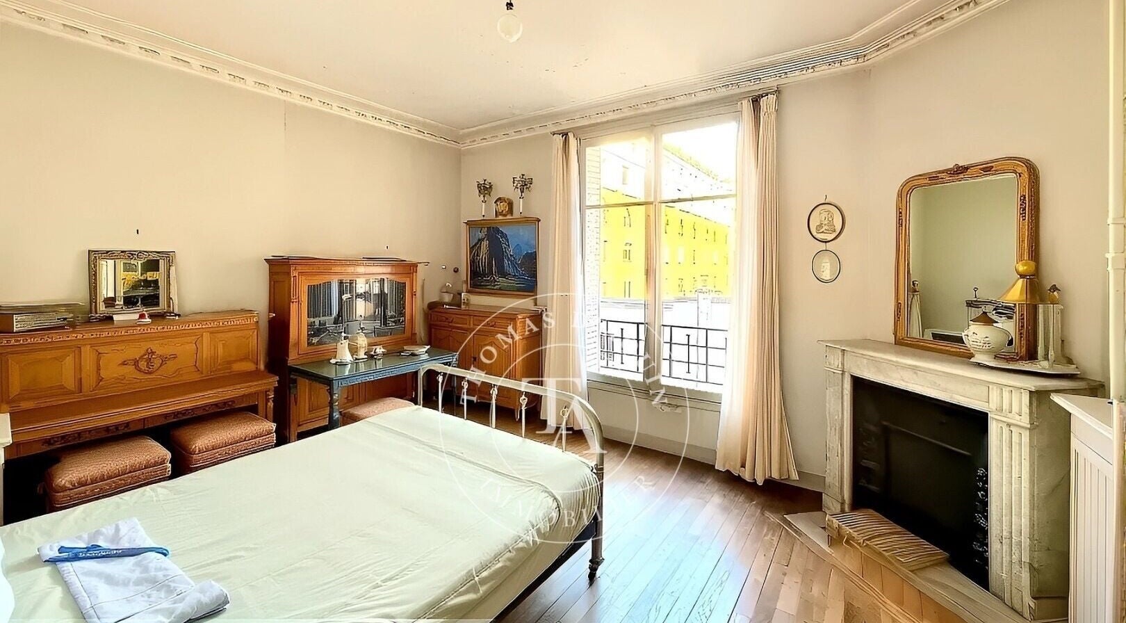 Charming room with vintage decor at Tibeauty in Paris, Île-de-france, FR, featuring a fireplace and antique furniture.