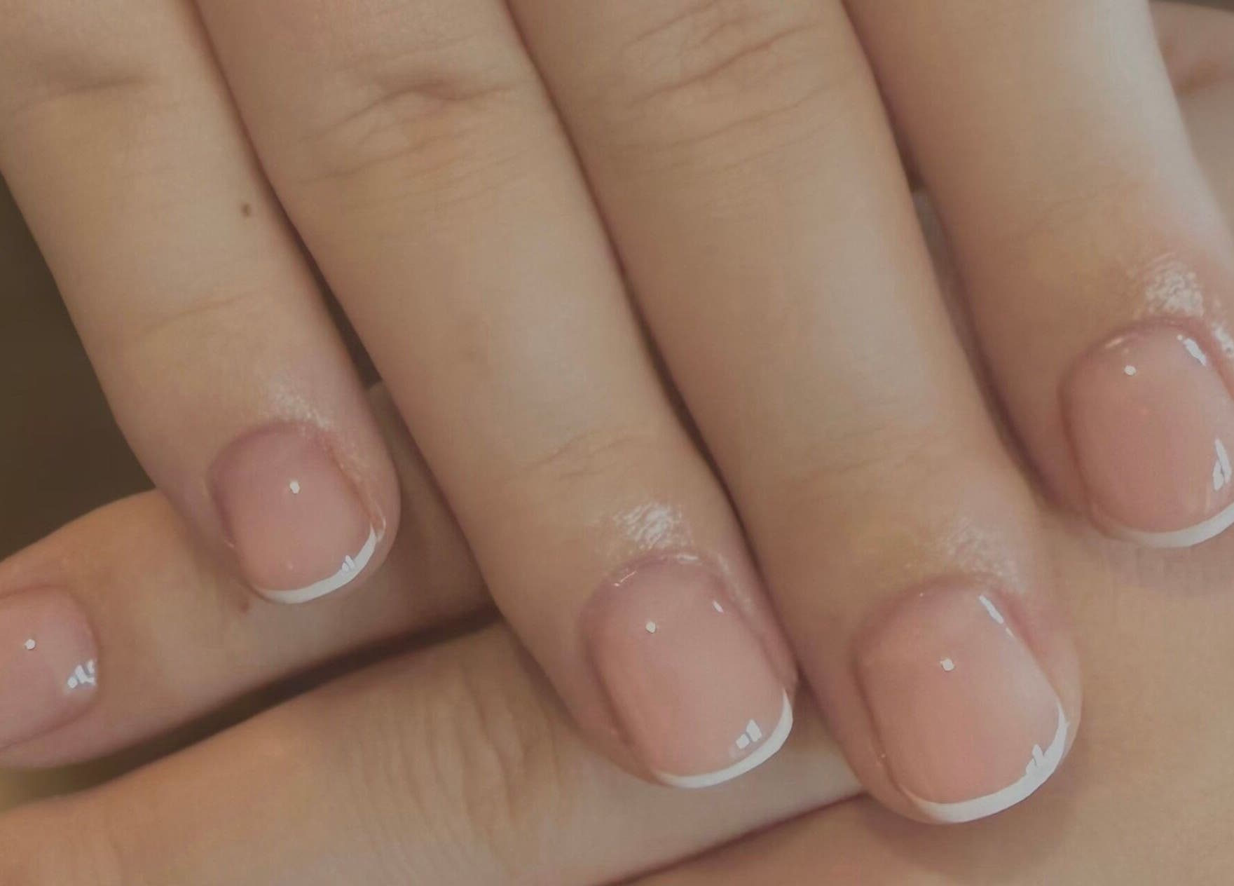 Classic French manicure at ByCerysB in Cambridge, England, GB, showcasing natural elegance and refined style.