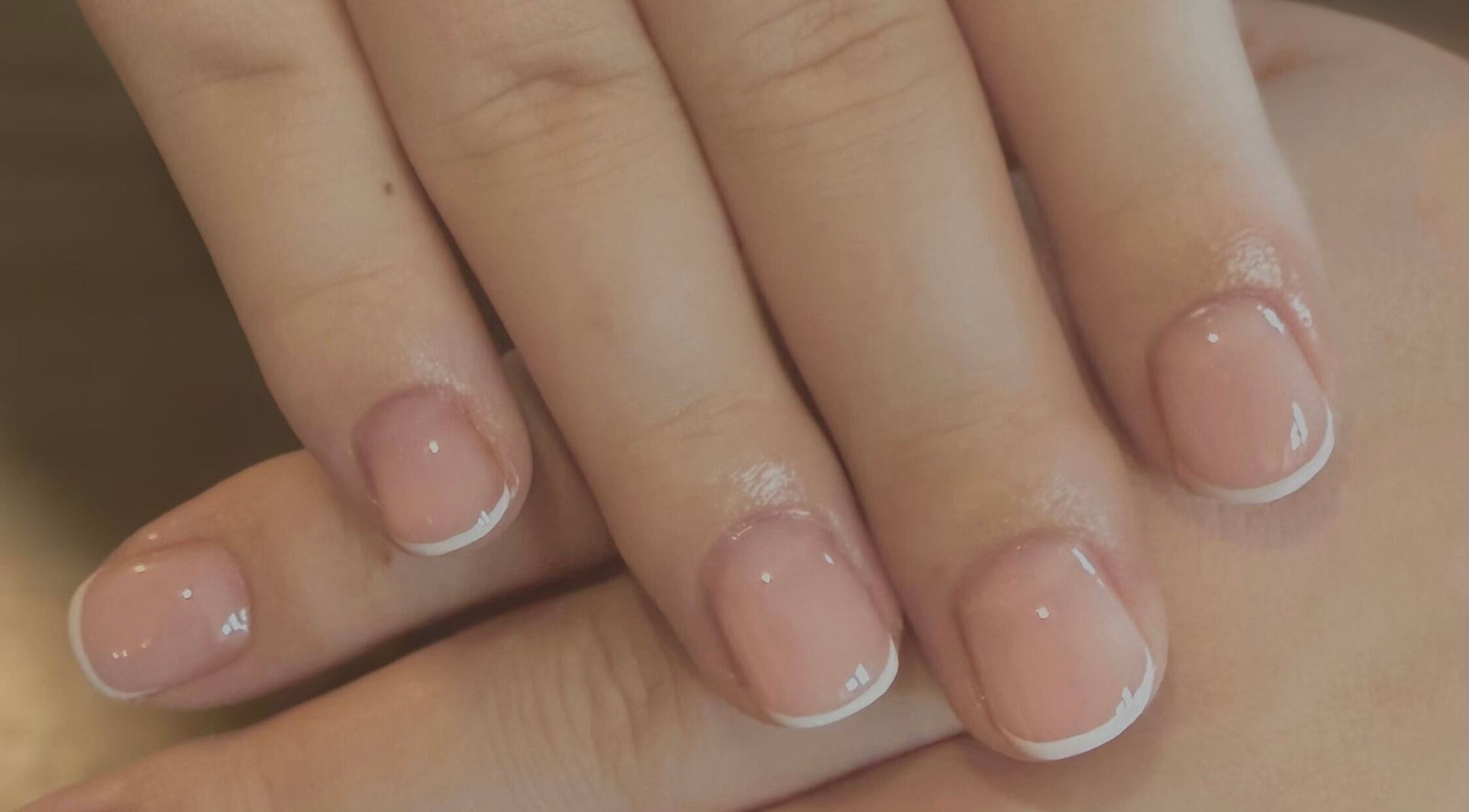 Classic French manicure at ByCerysB in Cambridge, England, GB, showcasing natural elegance and refined style.