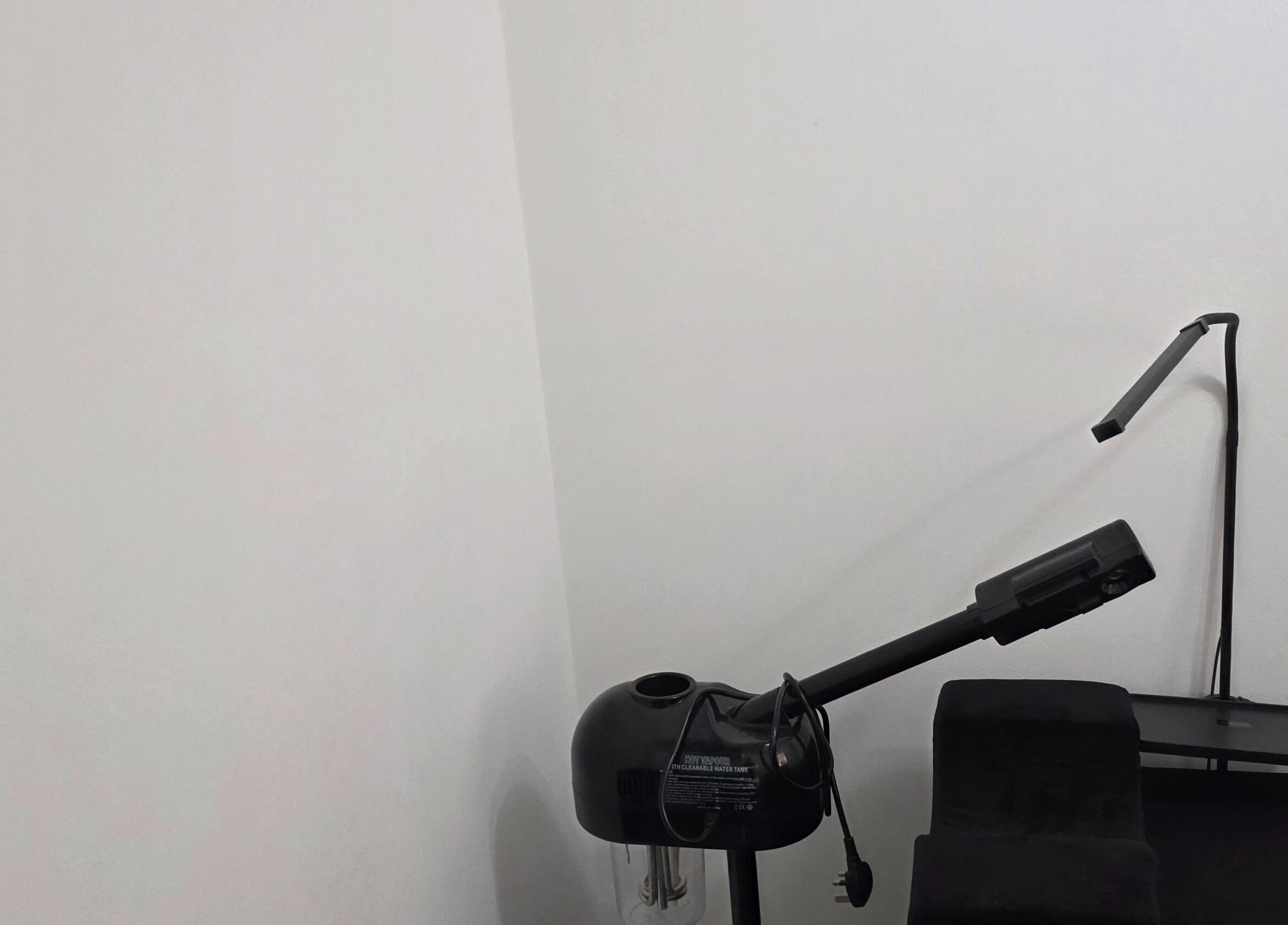 Minimalist skincare setup at Ink and Indulgence, Liverpool, England, GB featuring sleek black equipment.