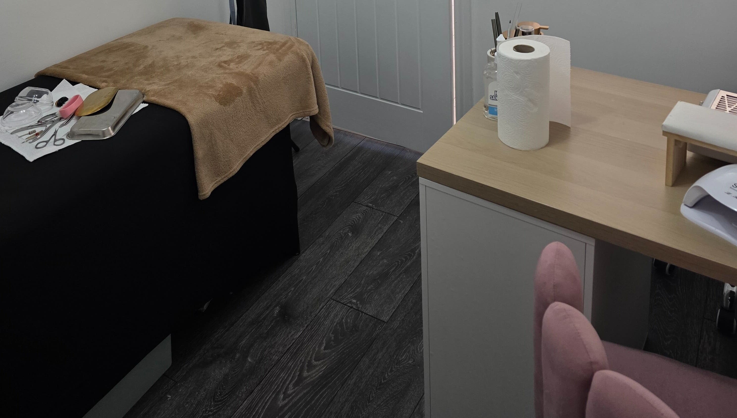 Cozy beauty treatment room at Ink and Indulgence, Liverpool, England, GB, featuring tools and a comfy bed.