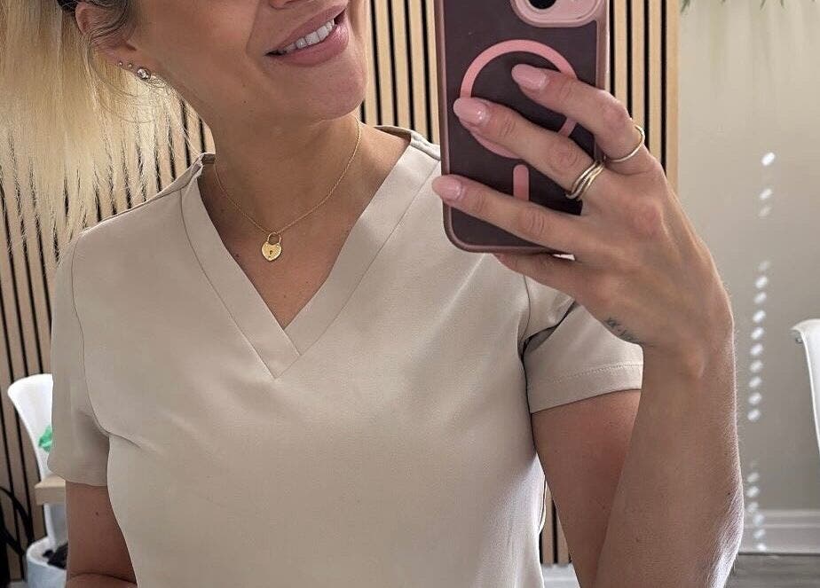 A professional taking a selfie at Kls Beauty, Marple, England, GB in a stylish, well-lit salon space.