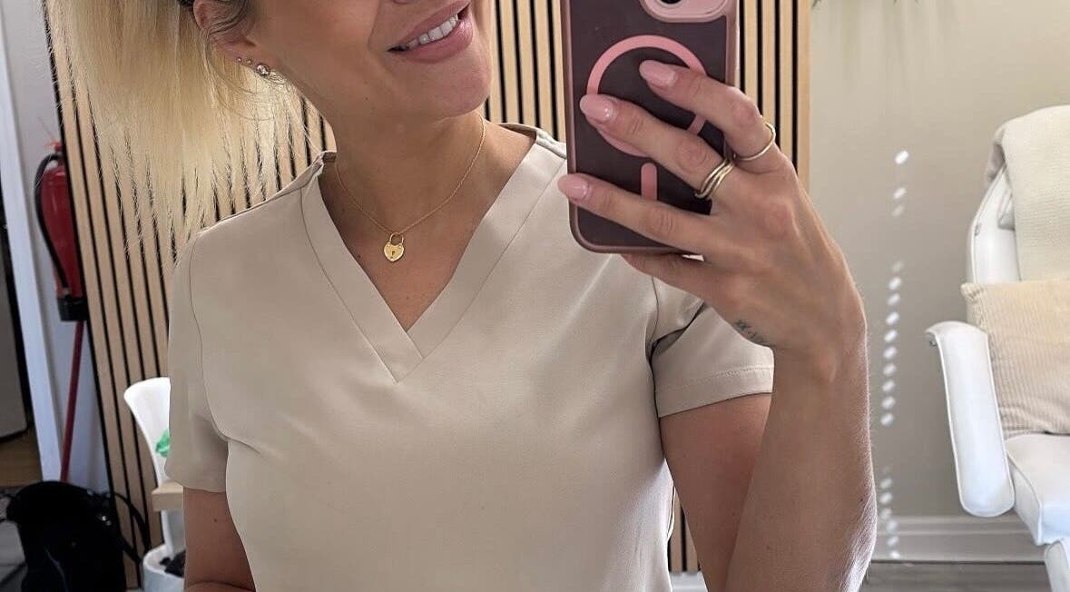 A professional taking a selfie at Kls Beauty, Marple, England, GB in a stylish, well-lit salon space.