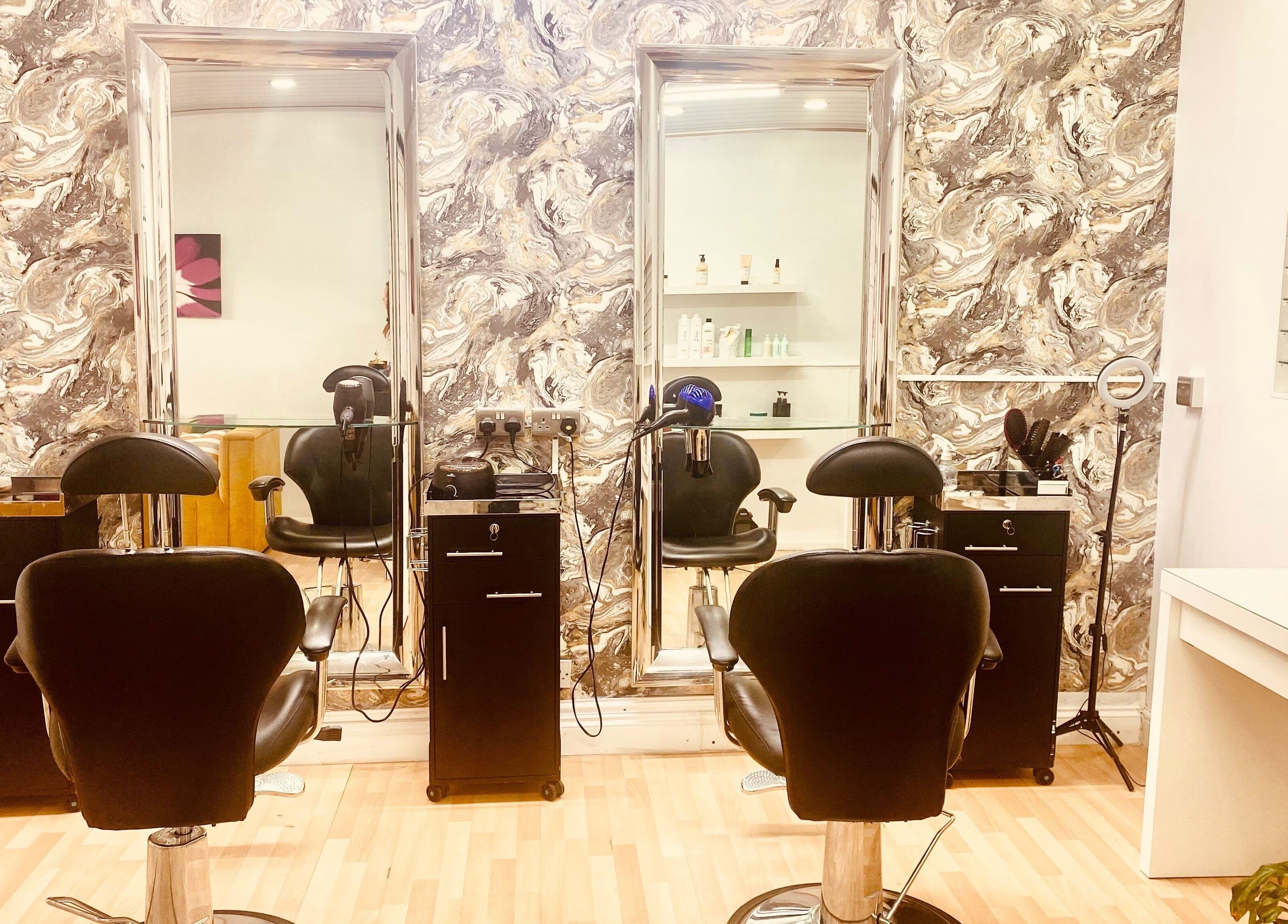 Stylish salon chairs and mirrors at Beauty Hub 131, Nelson, England, GB, showcasing modern elegance.